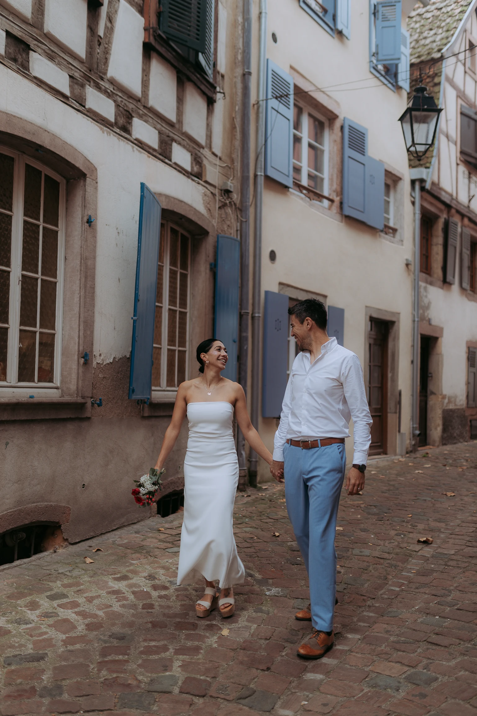 Elegant bride between colourful facades