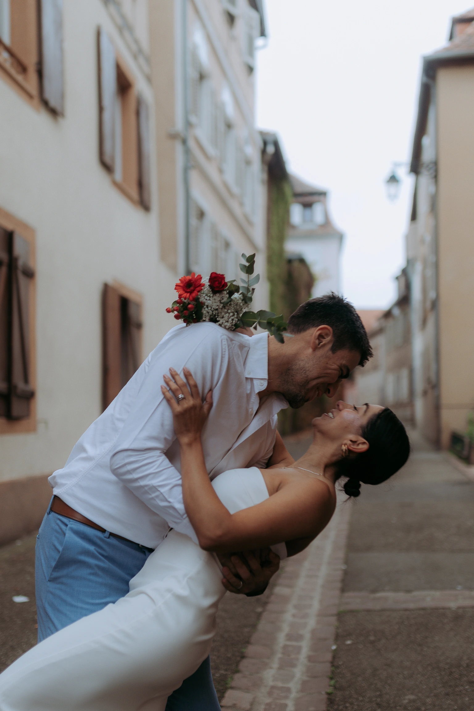 Dramatic dip kiss in an old-town alley