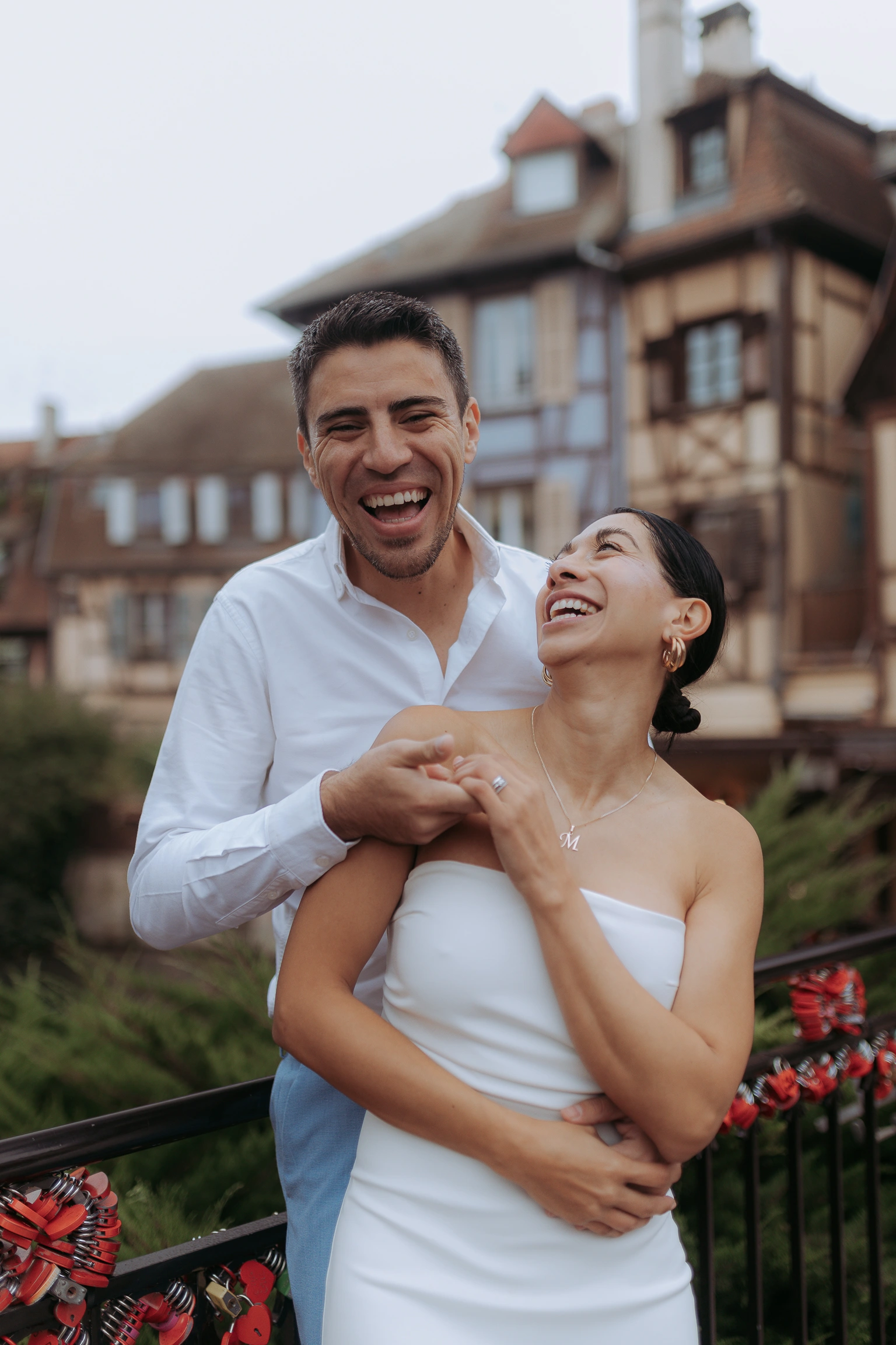 Laughing couple in front of half-timbered houses