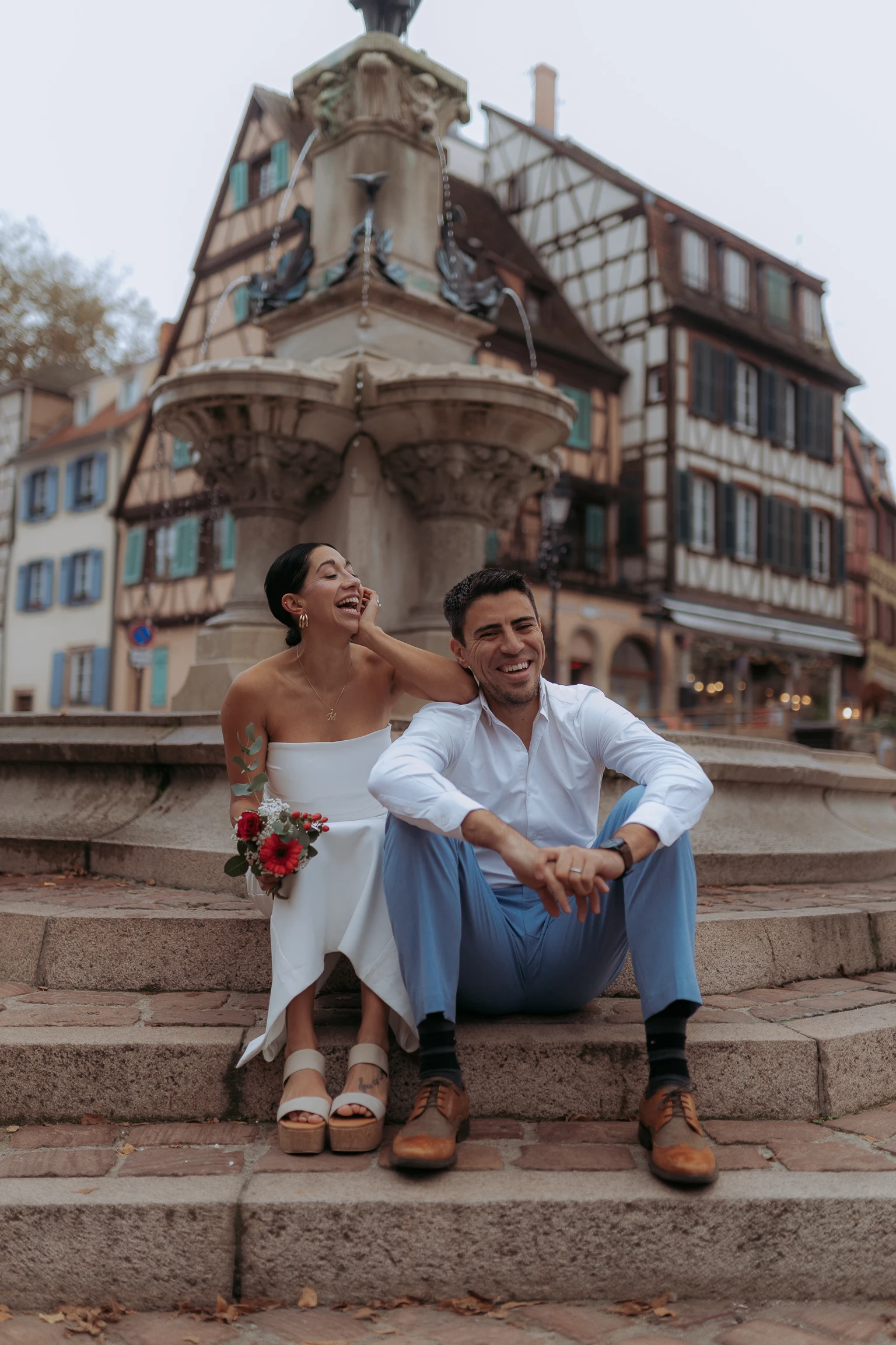 Couple on steps by a fountain