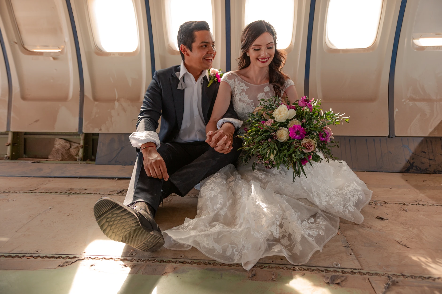 Couple with bouquet inside the plane