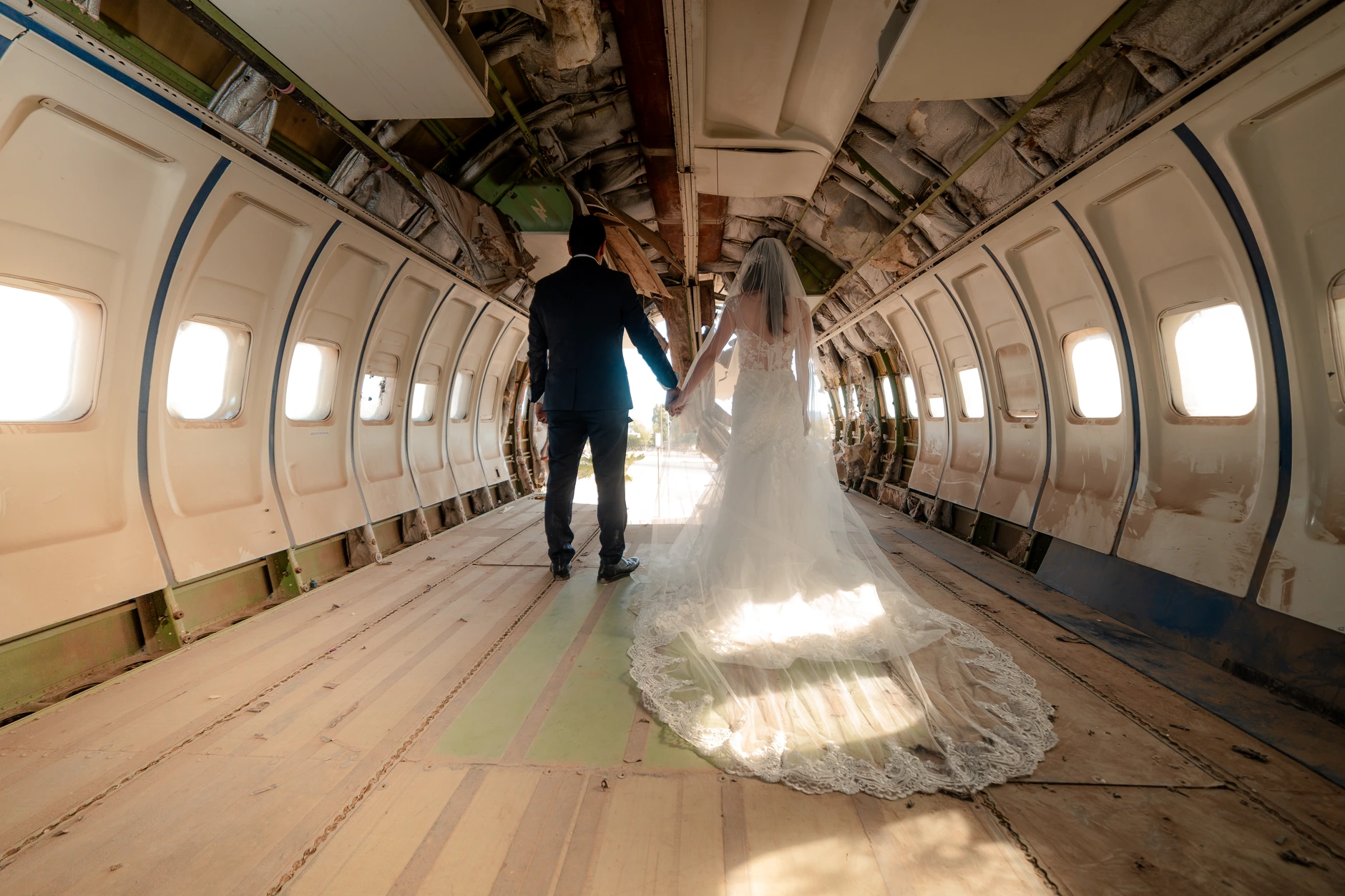 Groom walking along the aircraft aisle