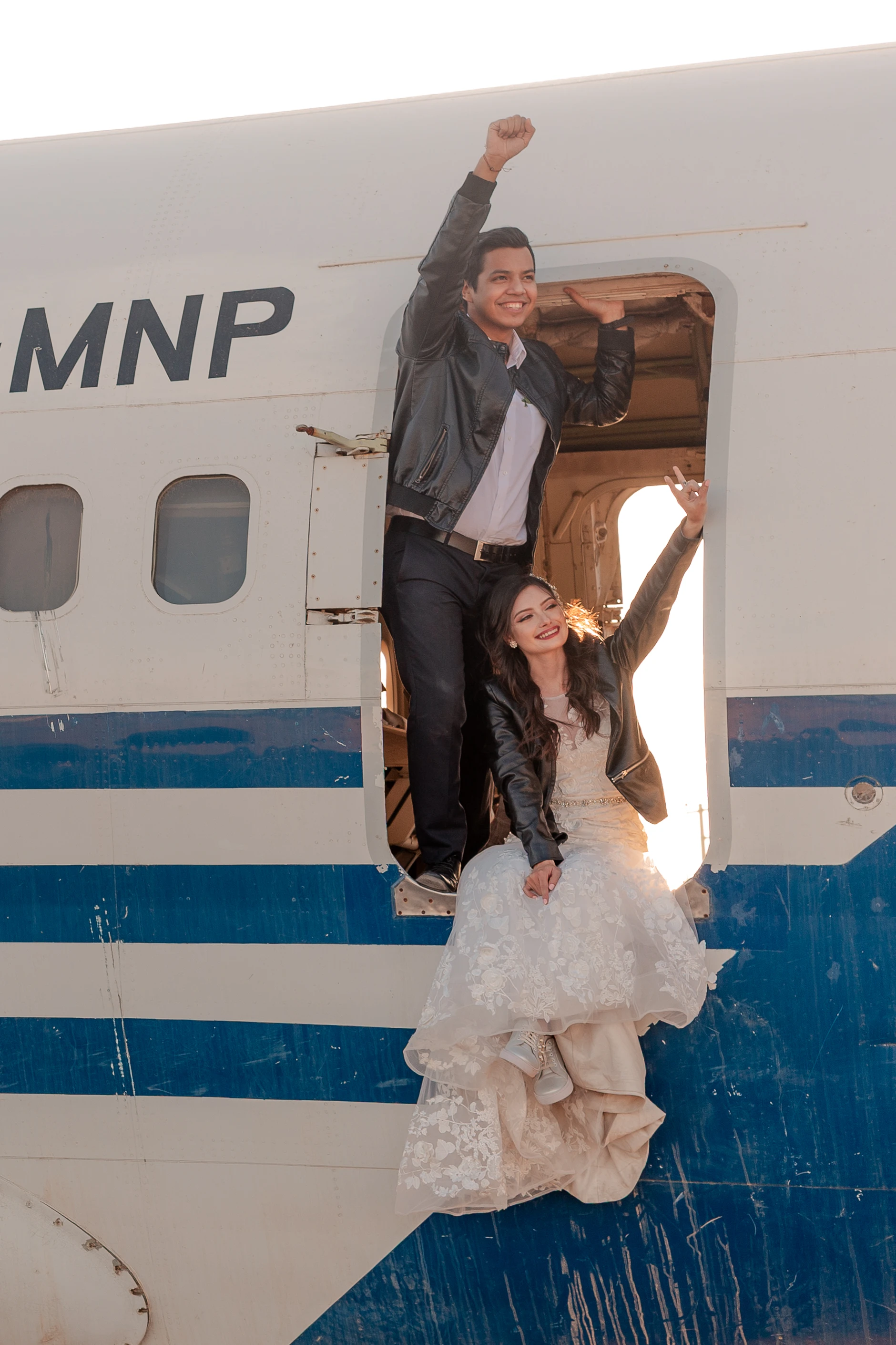 Bride in front of the striped fuselage