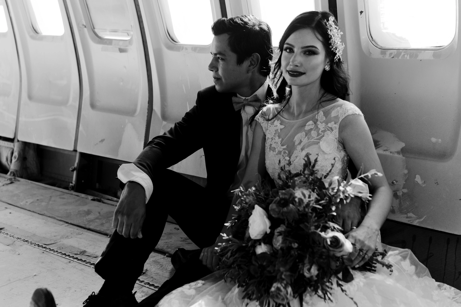 Black-and-white — couple seated inside the aircraft