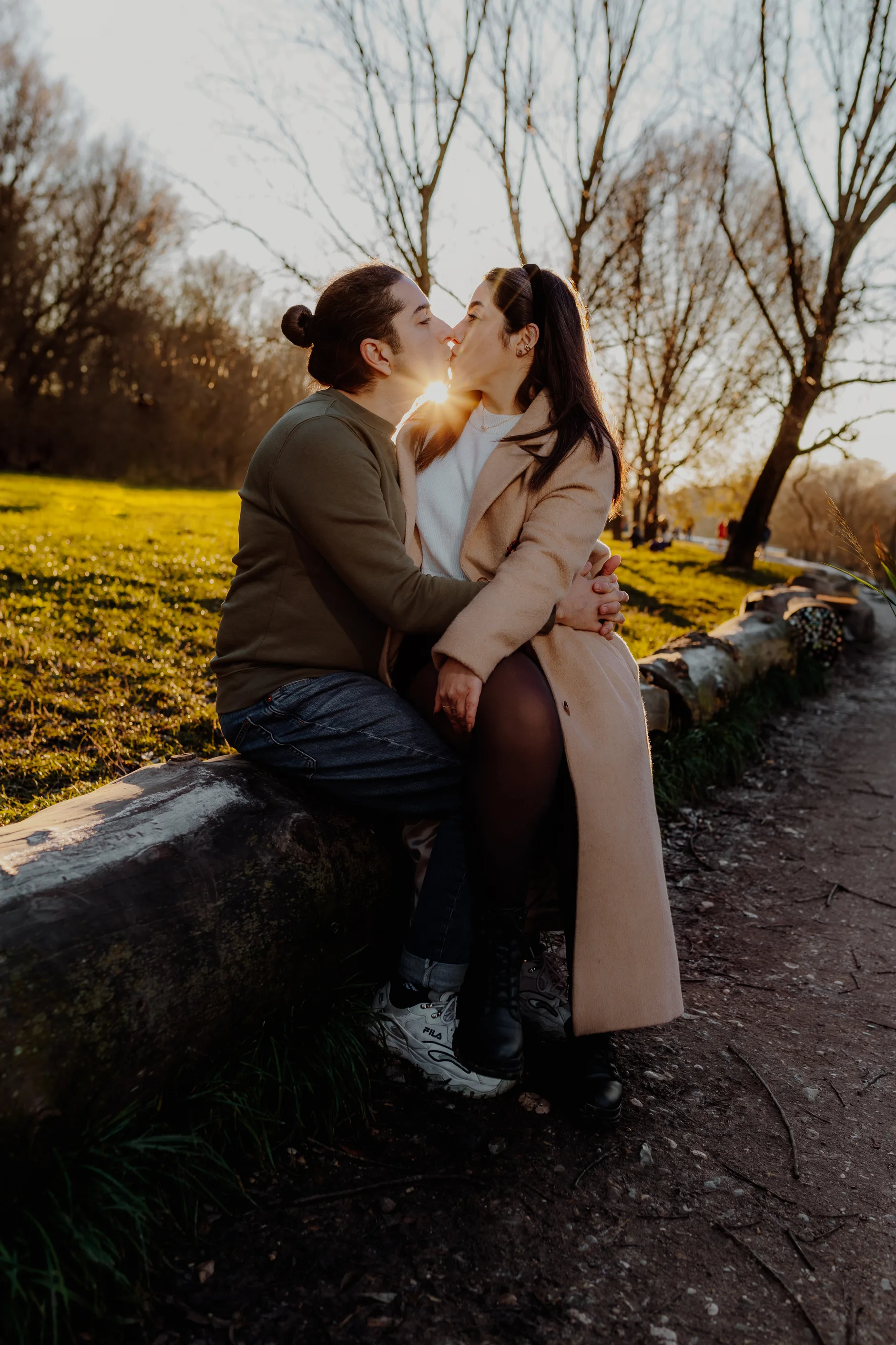 Gentle kiss as the couple walks along the Isar bank