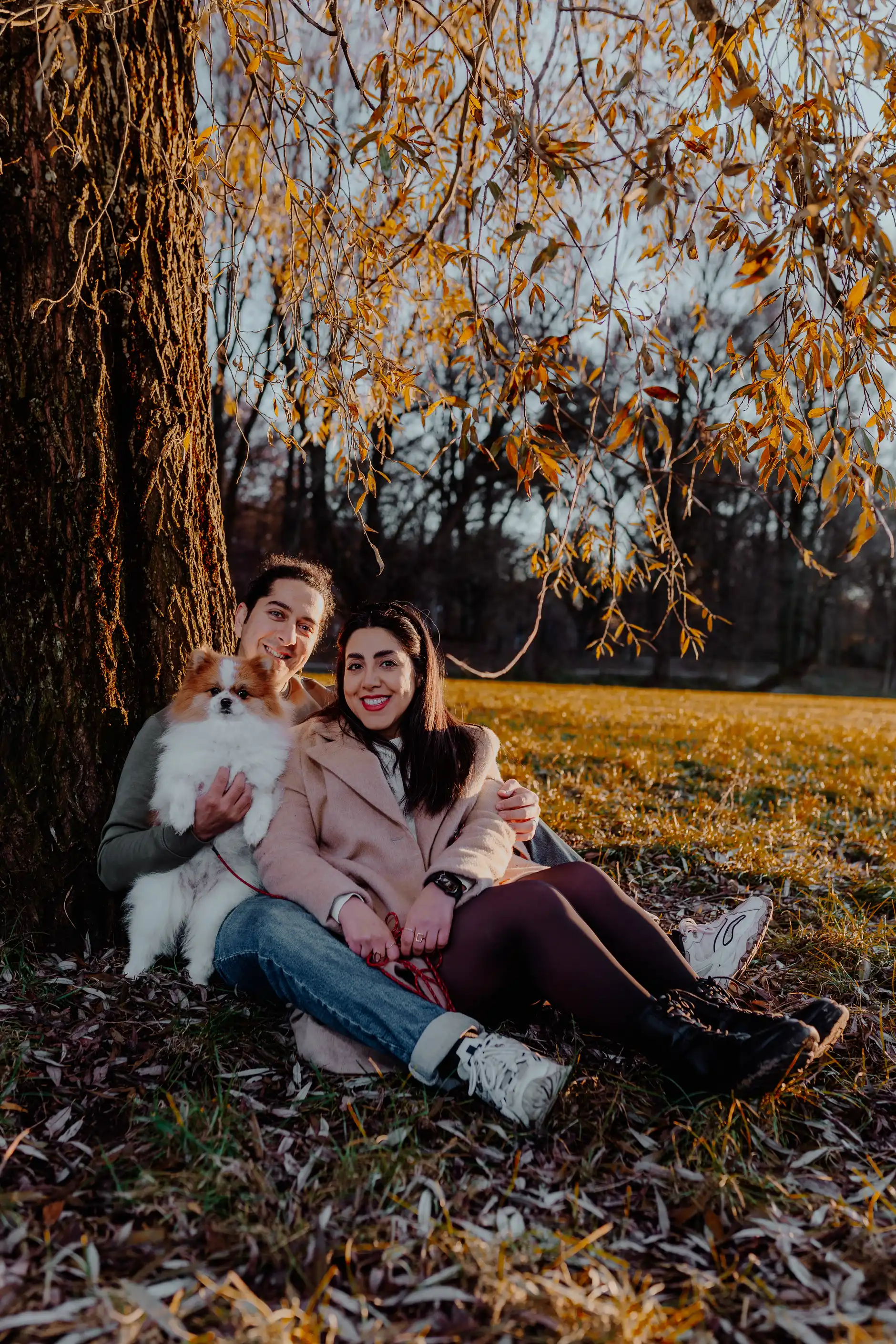Couple lying relaxed in the grass with warm autumn colours