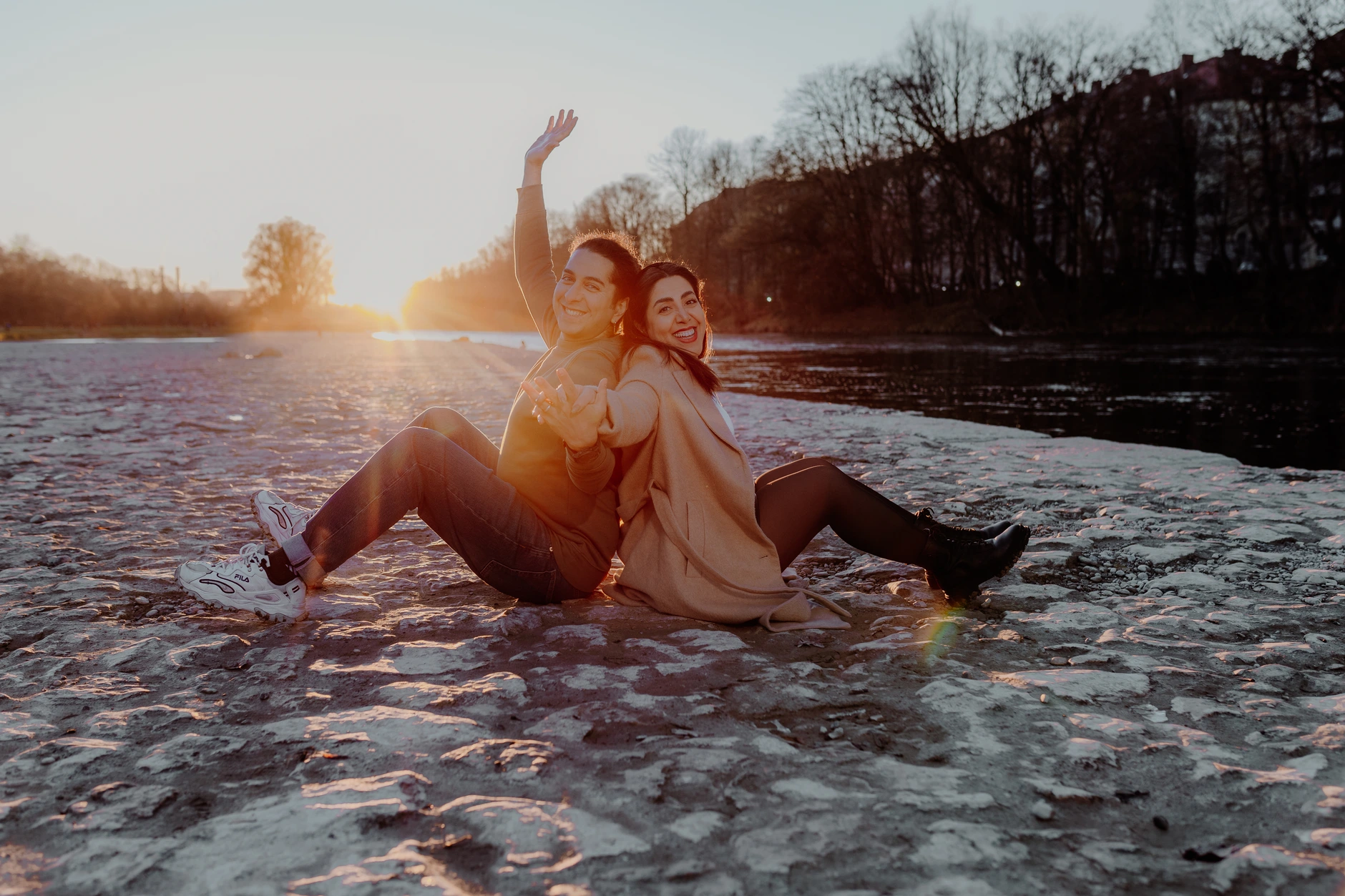 Couple walking along the gravel path beside the river