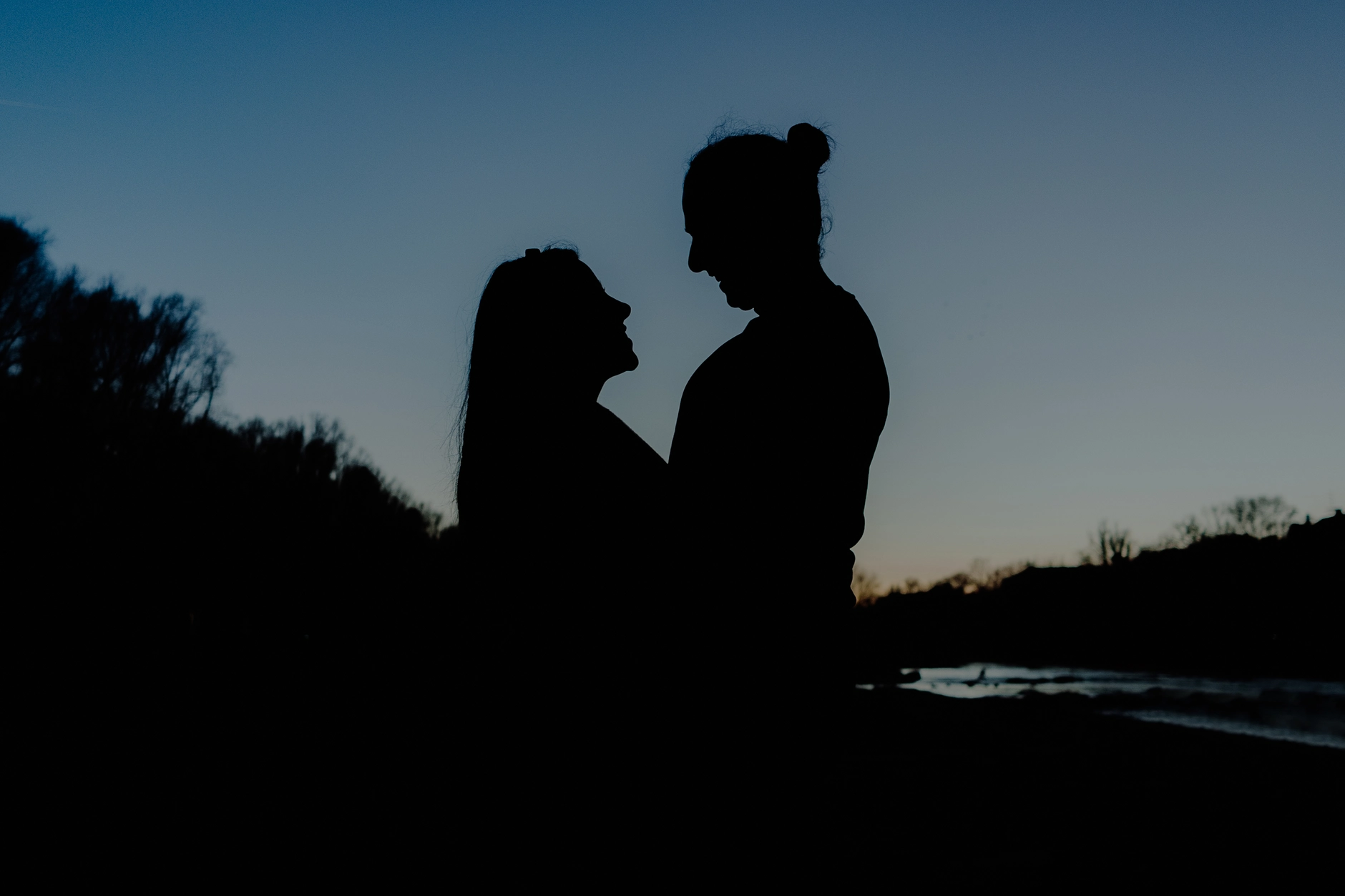 Nearly final portrait — couple walking into the last rays of sunlight