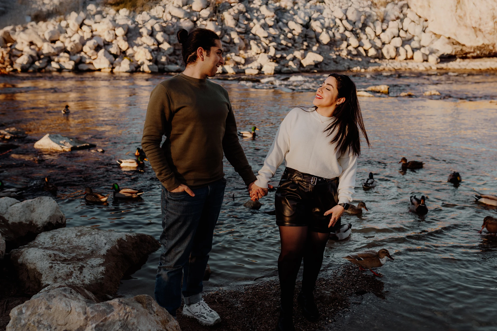 Couple wading through the shallow water of the Isar