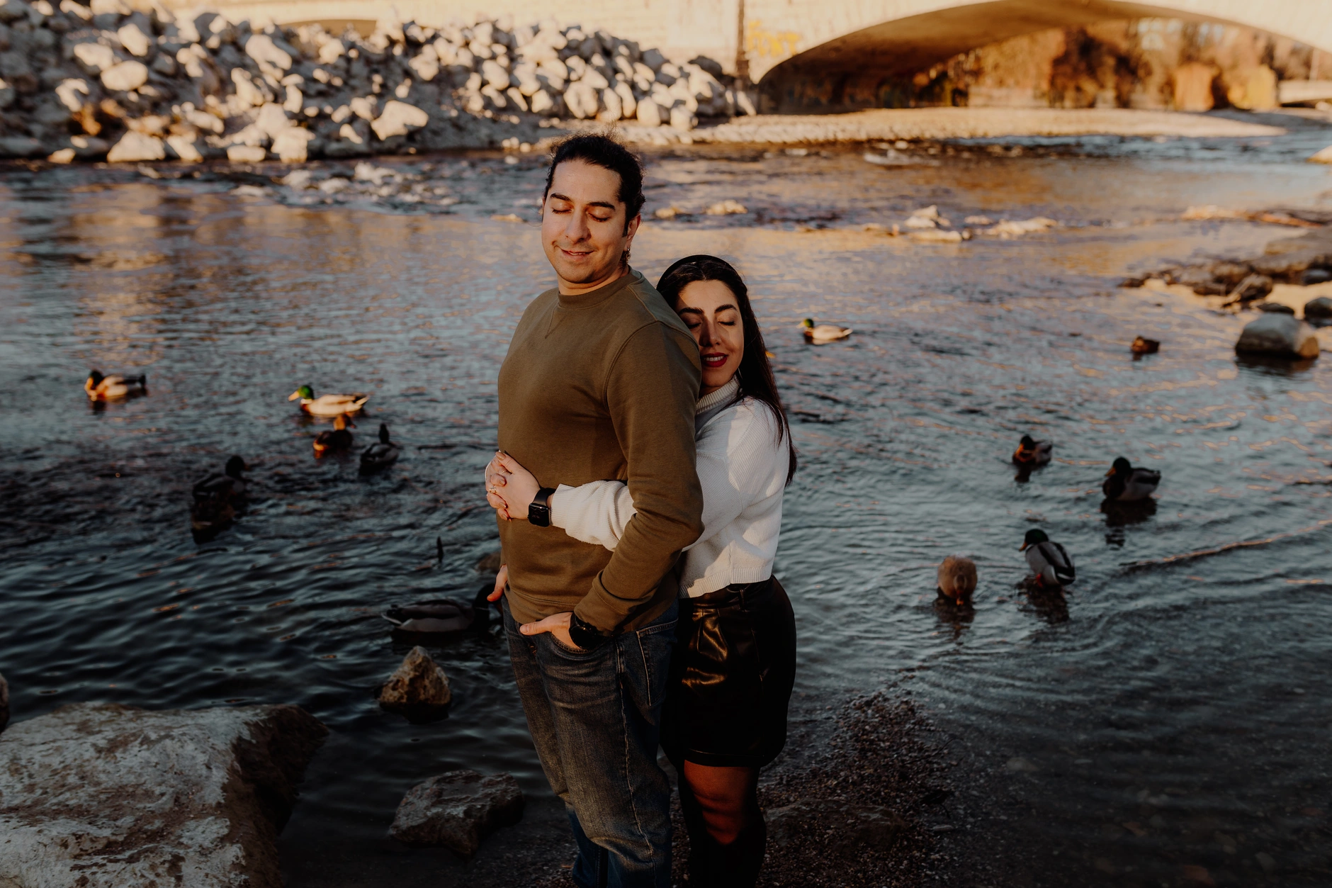 Portrait of the woman at the riverbank in golden light