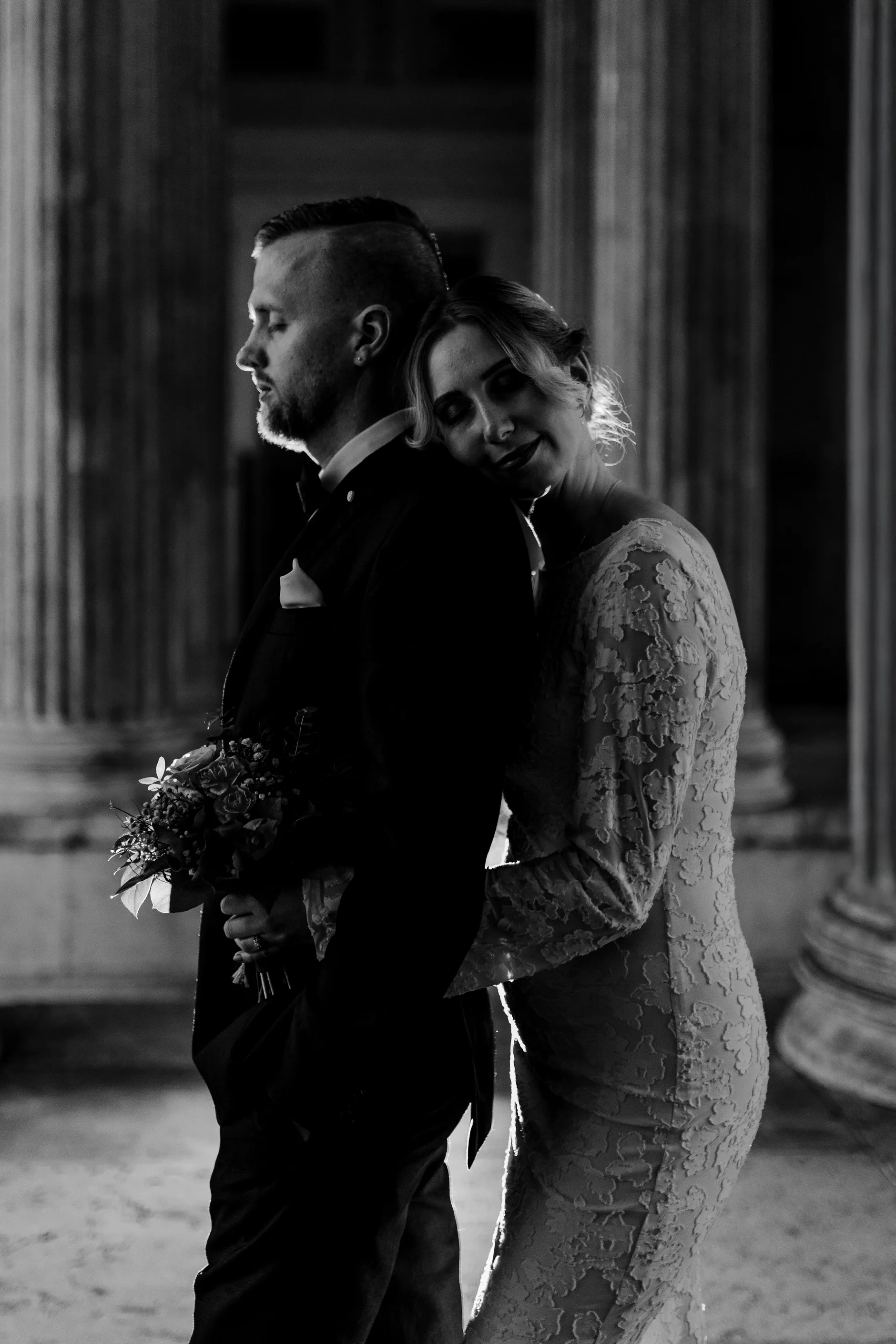 Wide black-and-white shot in the colonnade corridor