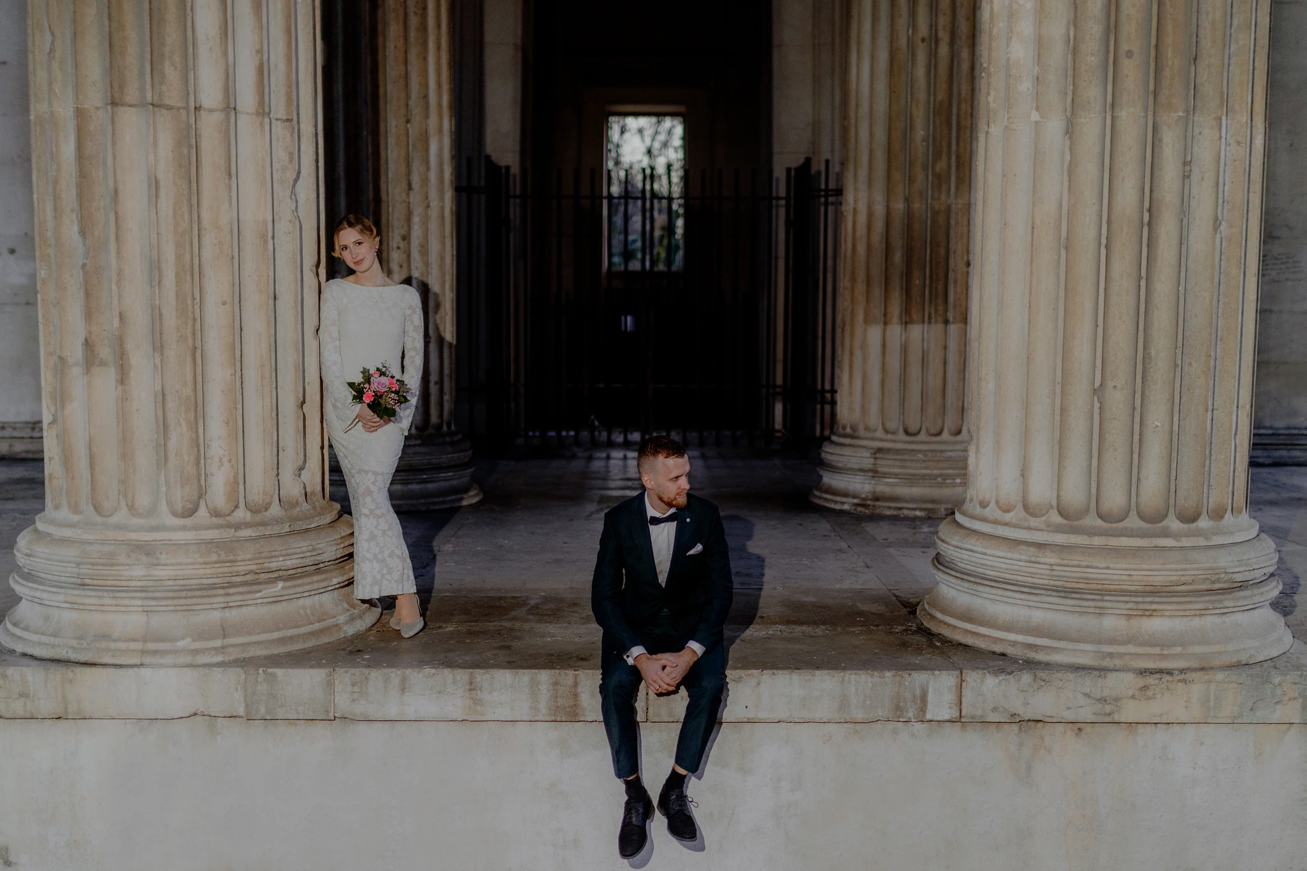 Groom strides through the dark column hall