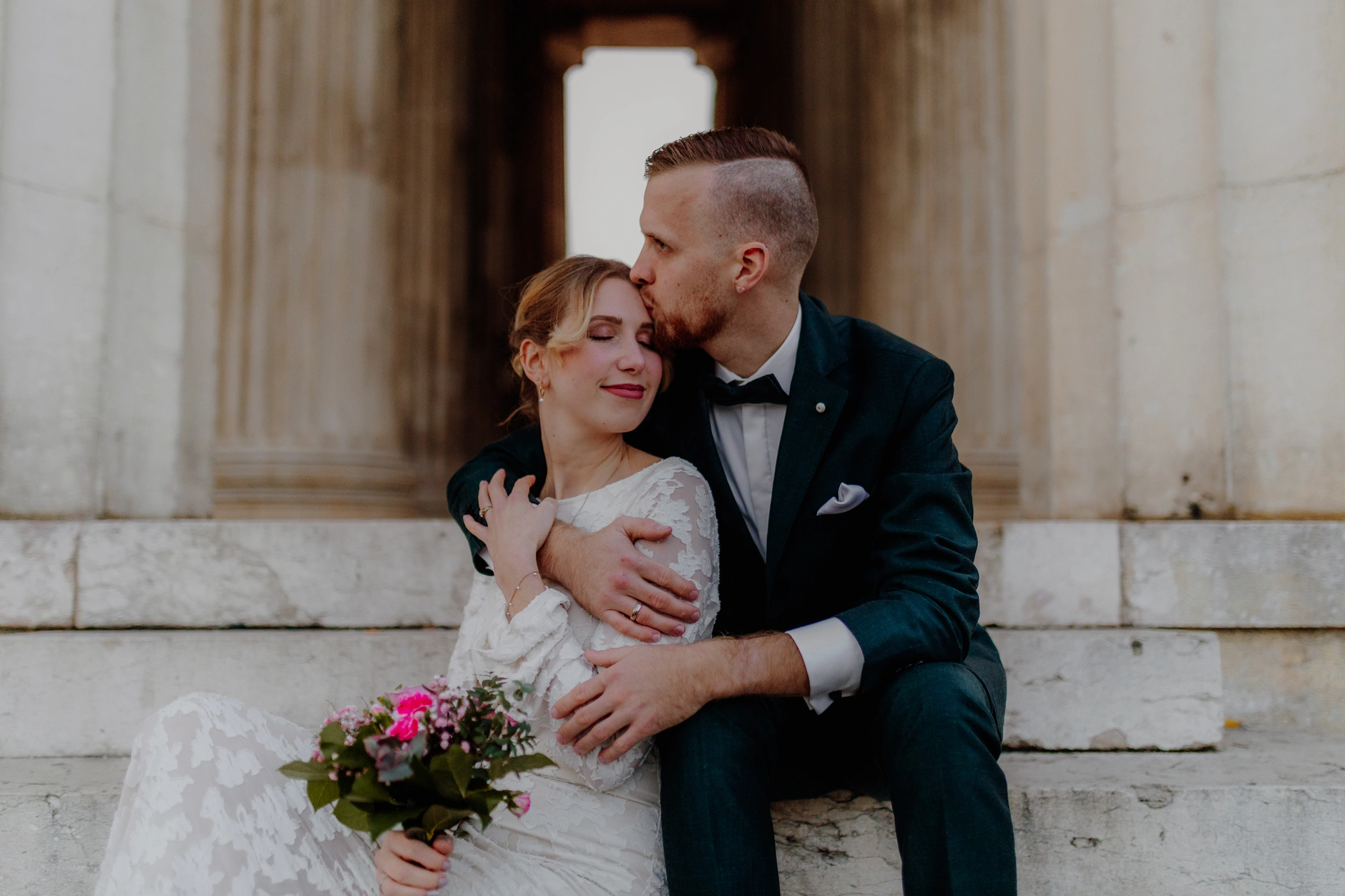 Tender moment — couple's foreheads touching in soft shadow