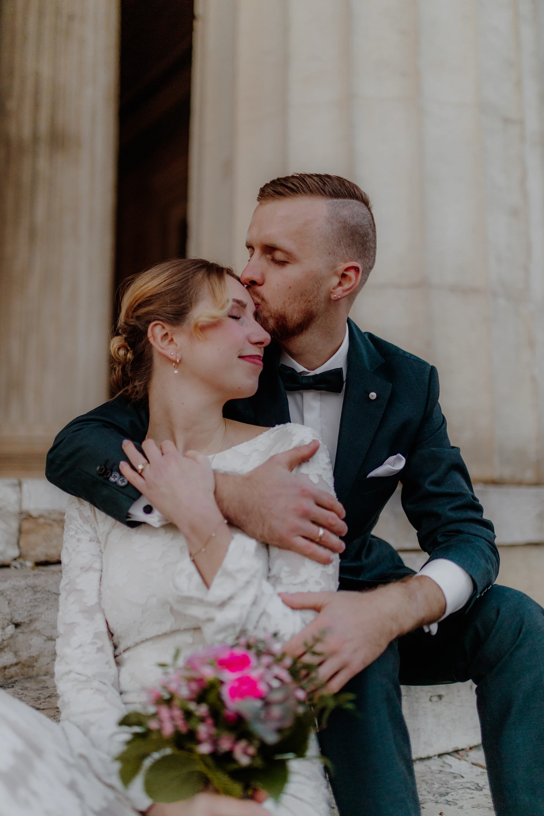 Groom gazing up at the monumental architrave