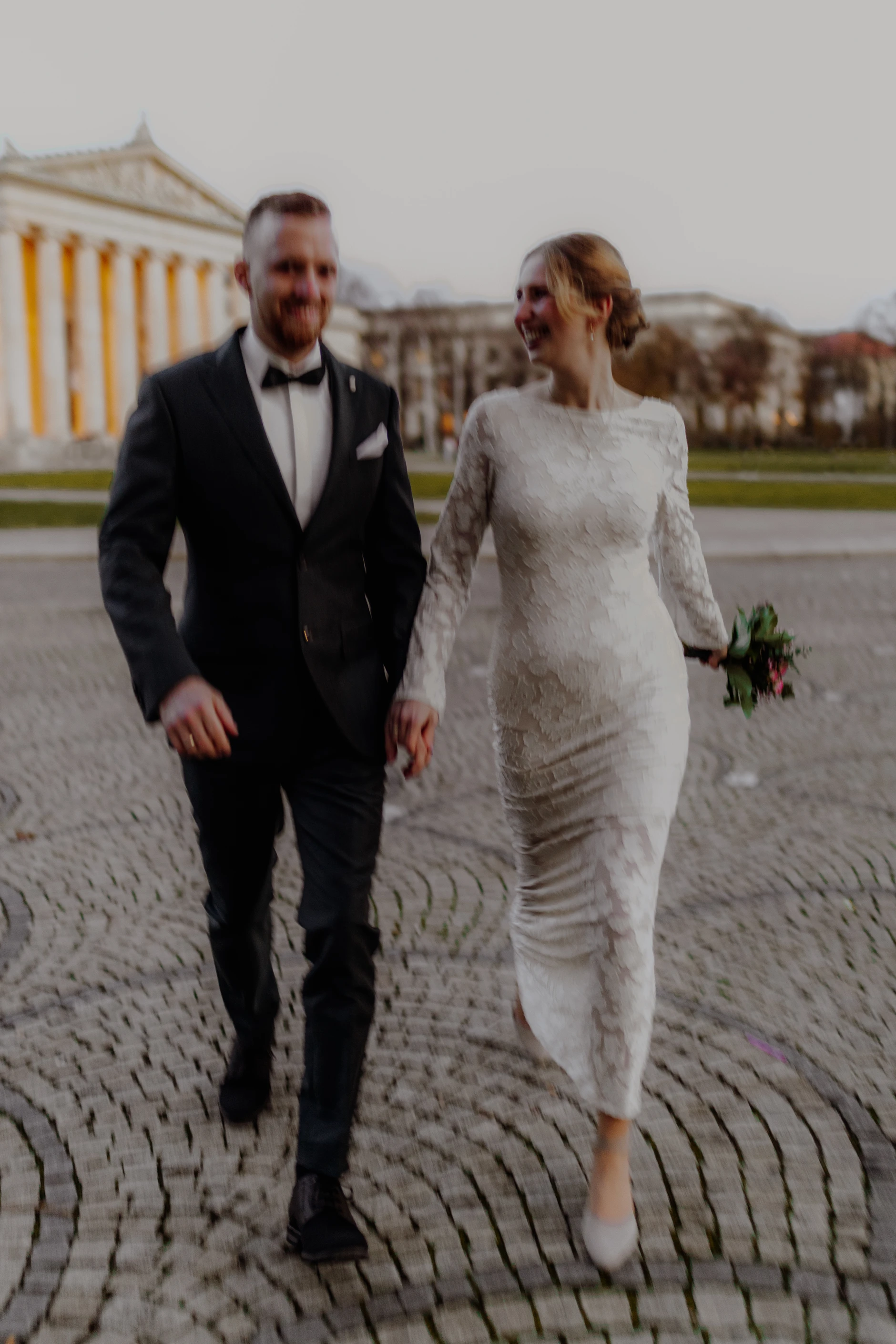 Black-and-white full-length portrait at the base of the columns