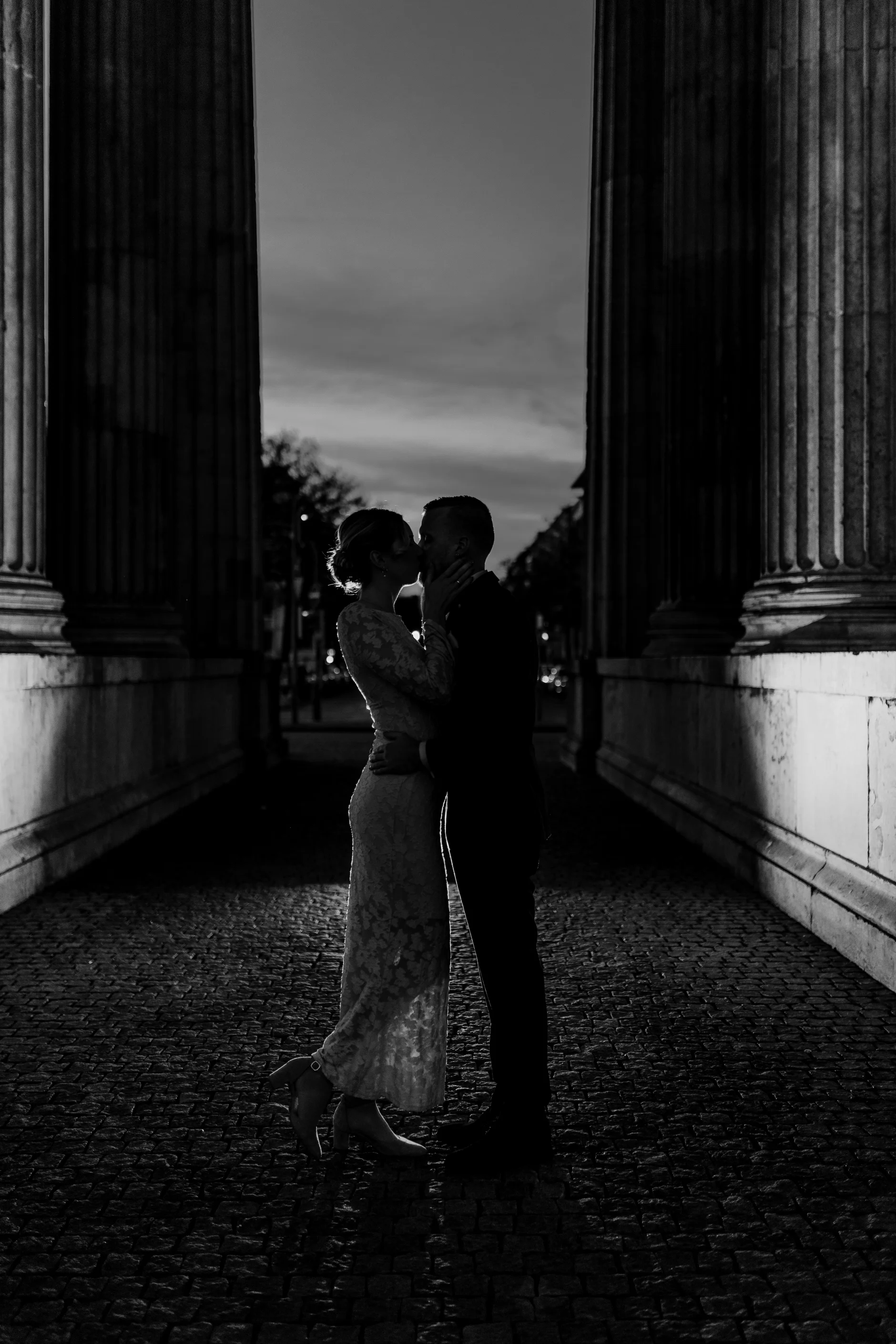 Playful candid — couple laughing against the stone
