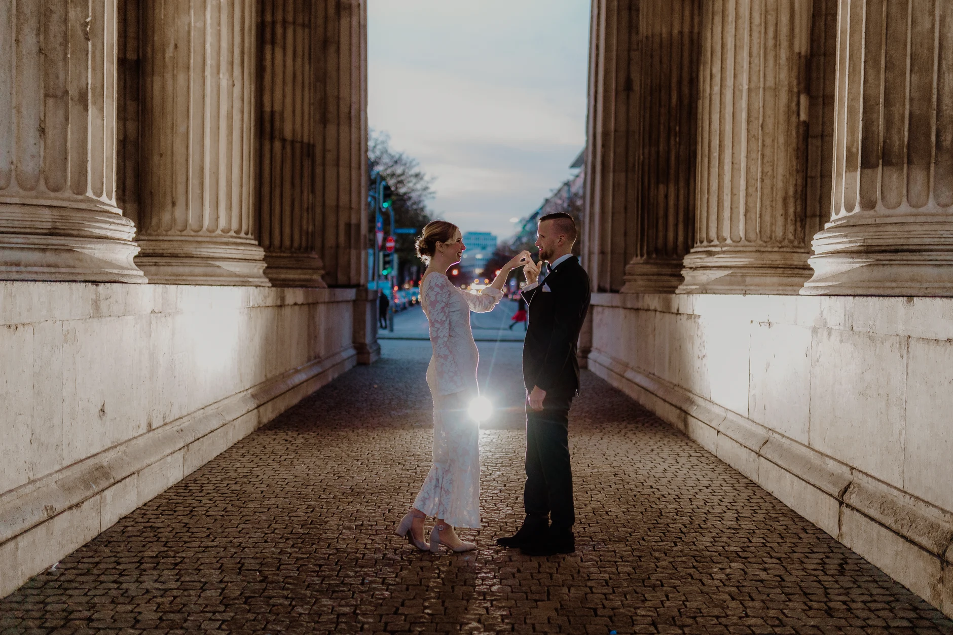 Grand single portrait: groom framed by the columns