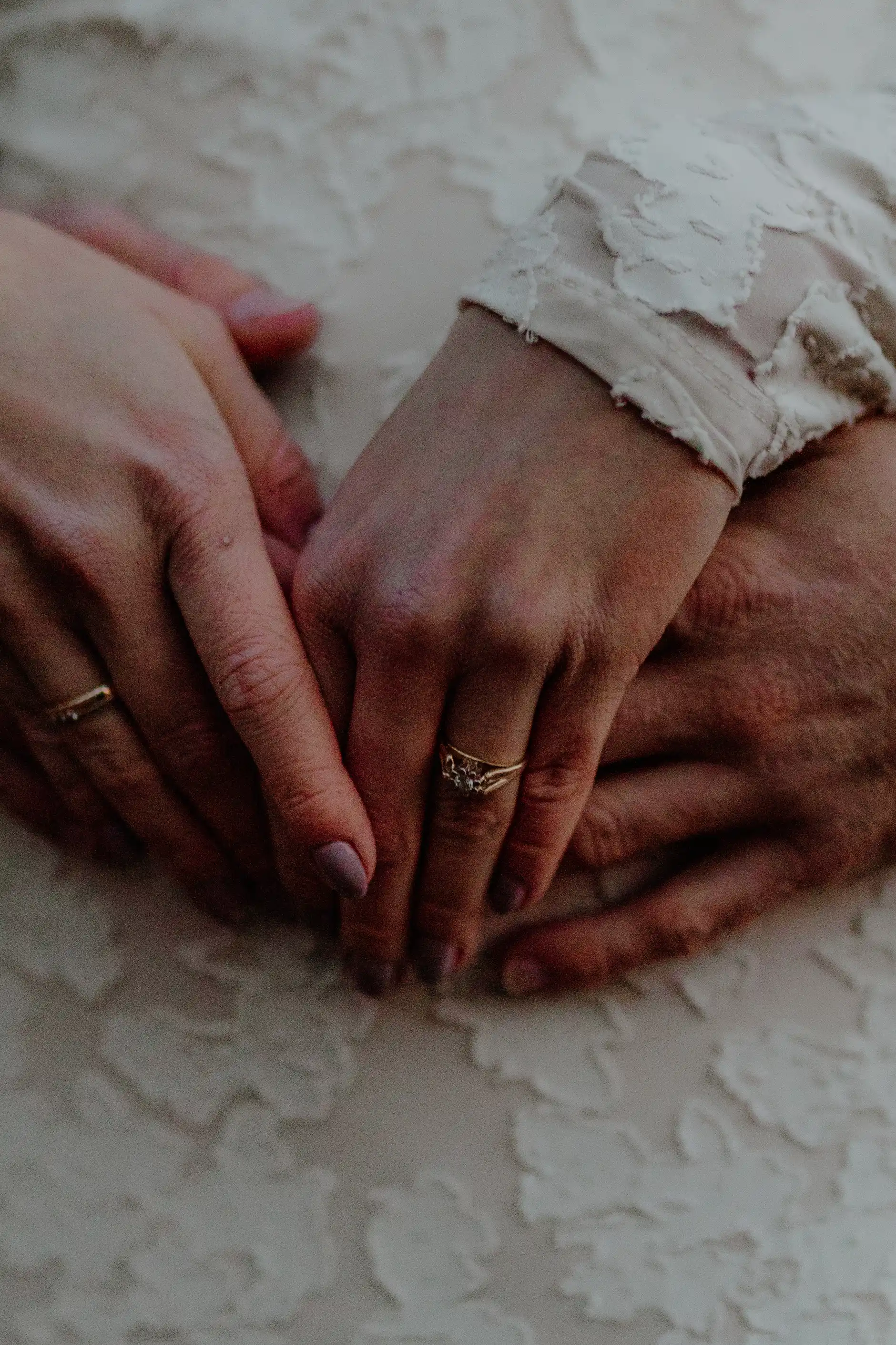 Bride reaching up to touch a column capital