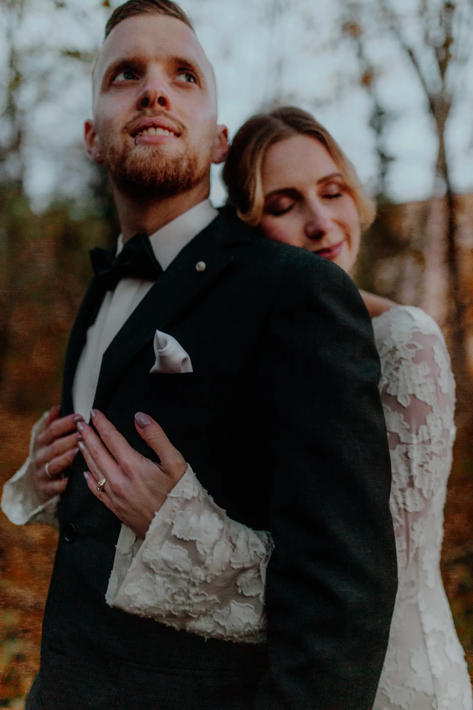 Wide landscape — couple dwarfed by the immense colonnaded hall