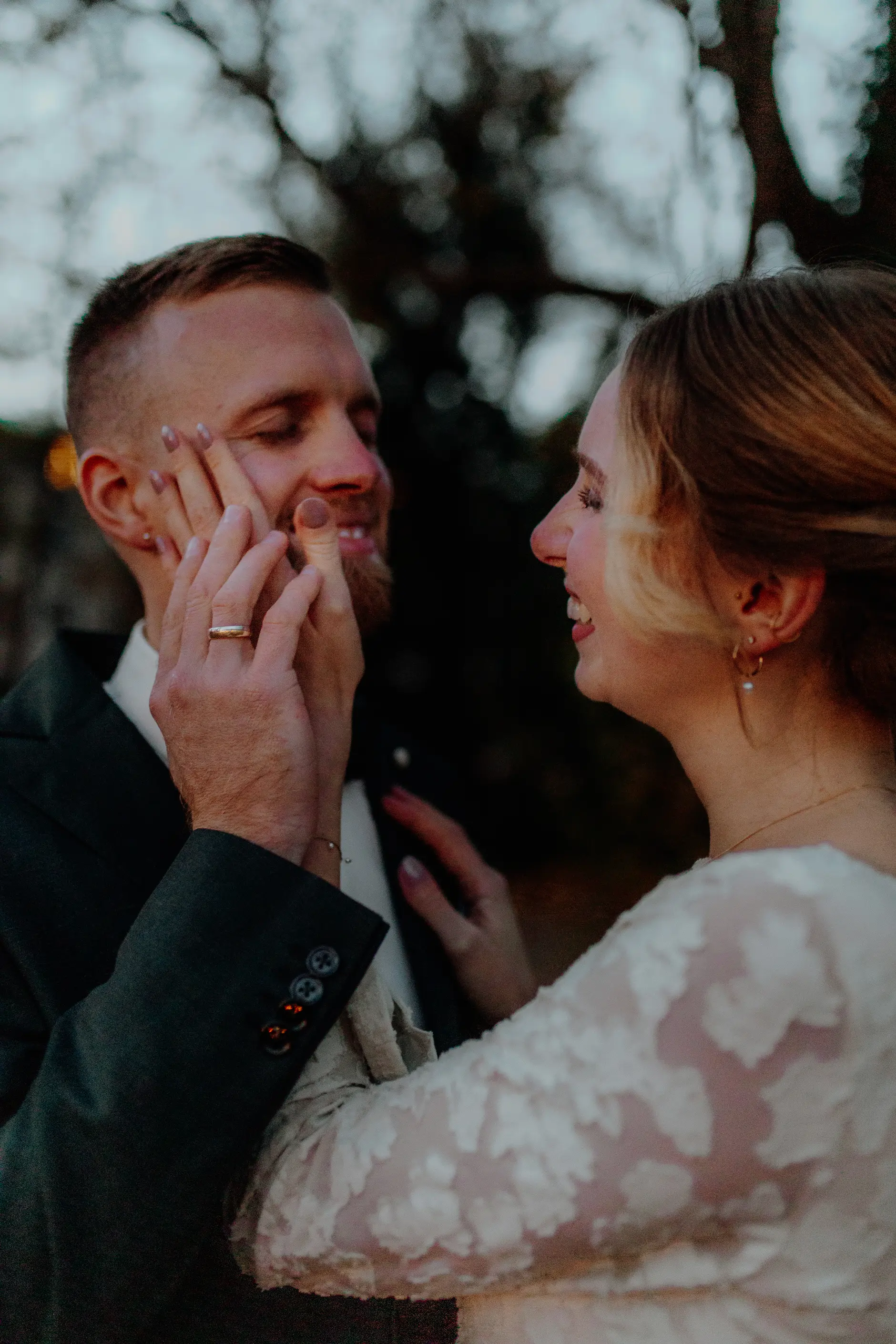 Groom and bride — quiet look between them in the corridor