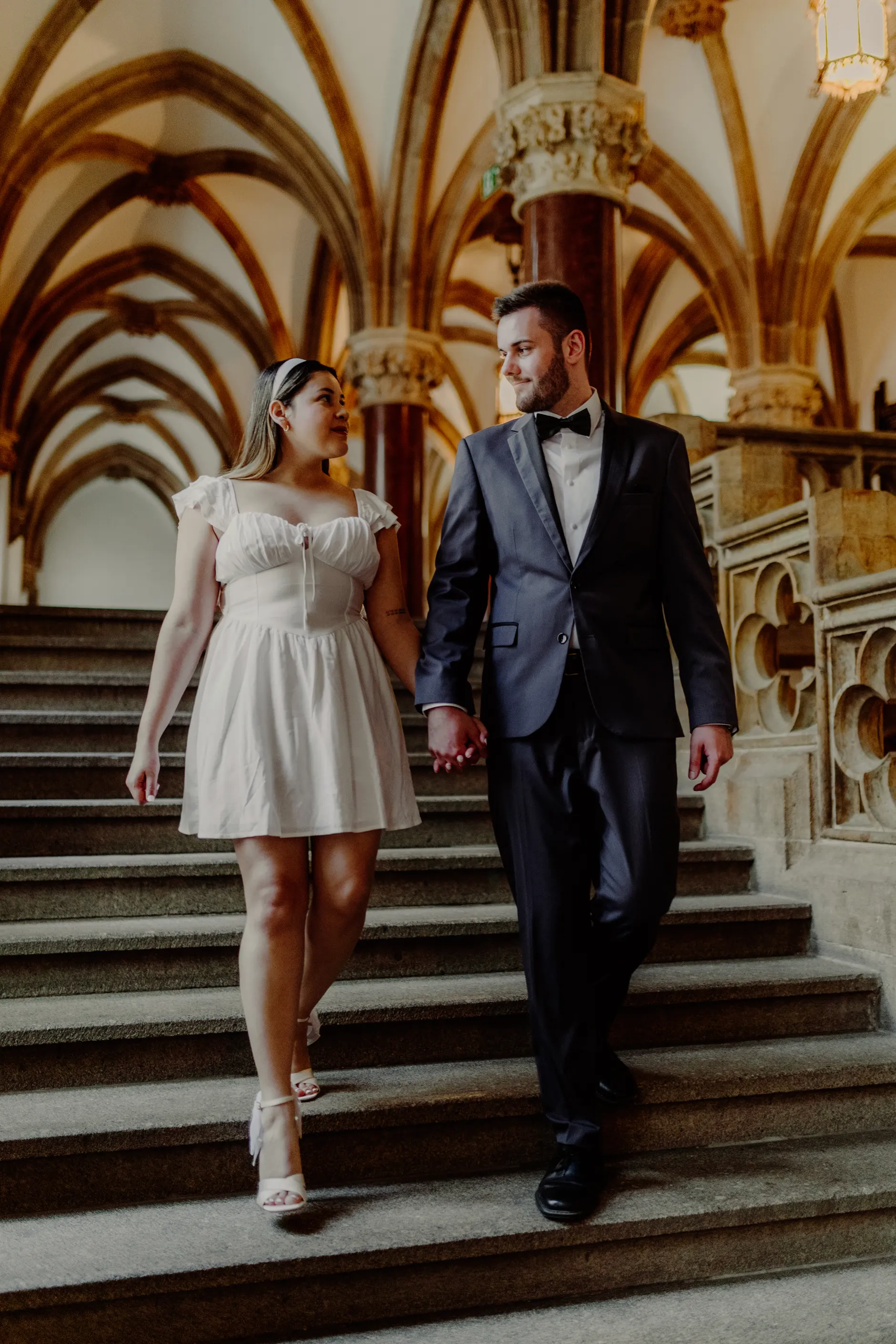 Black and white detail of the couple hands and outfits
