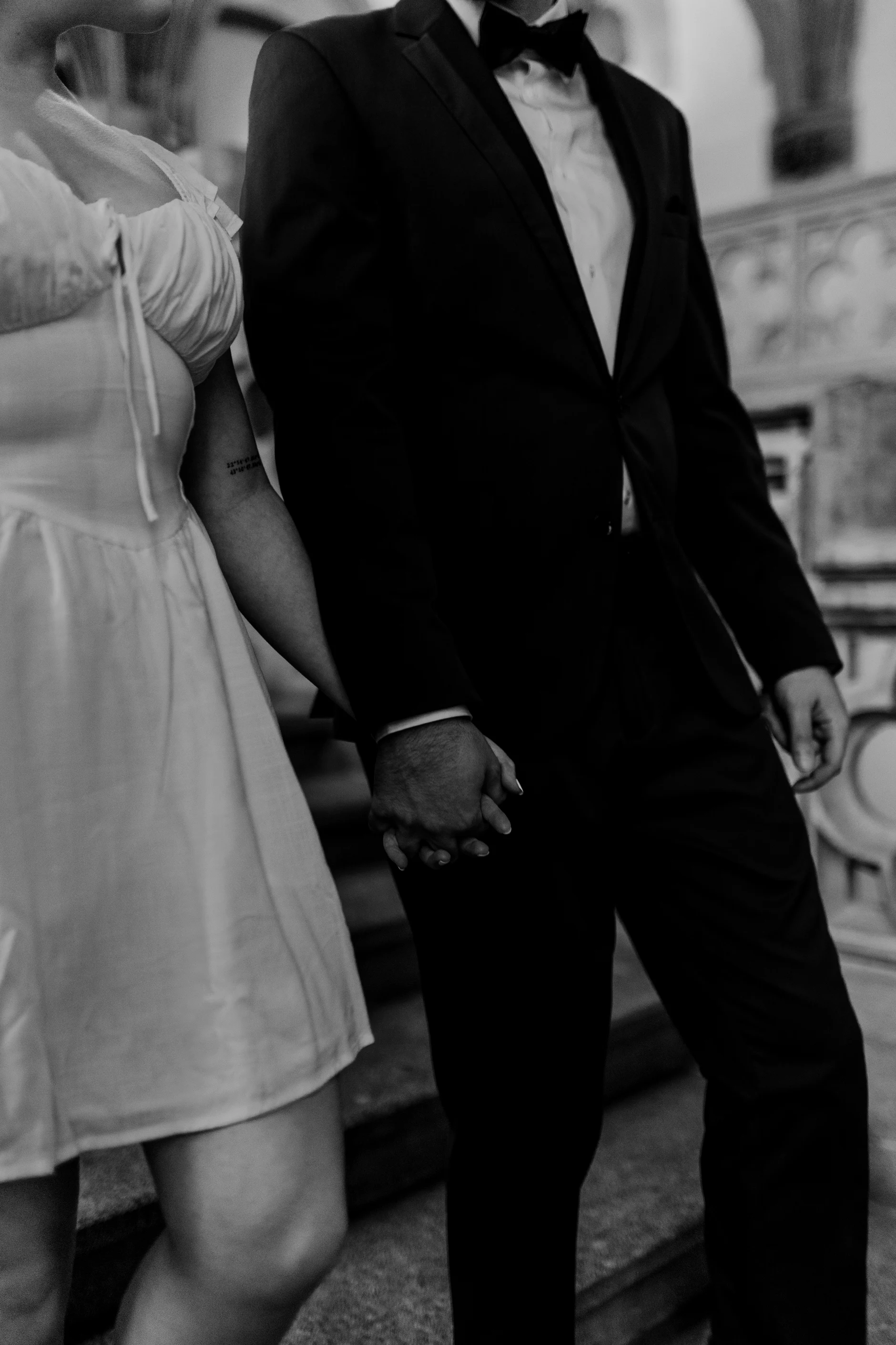 Cropped black and white walking portrait of the couple
