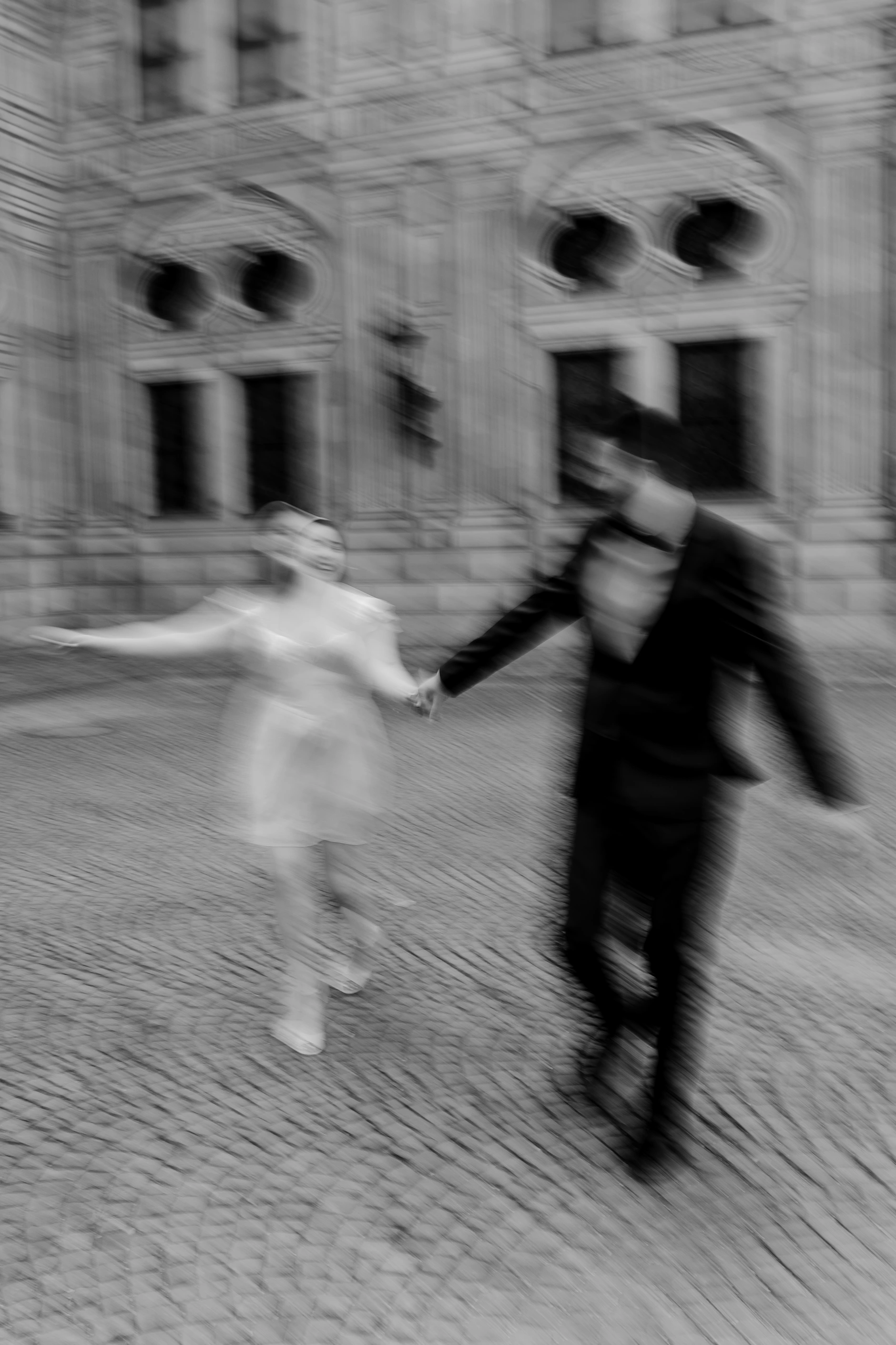 Playful spin in front of gothic city hall windows