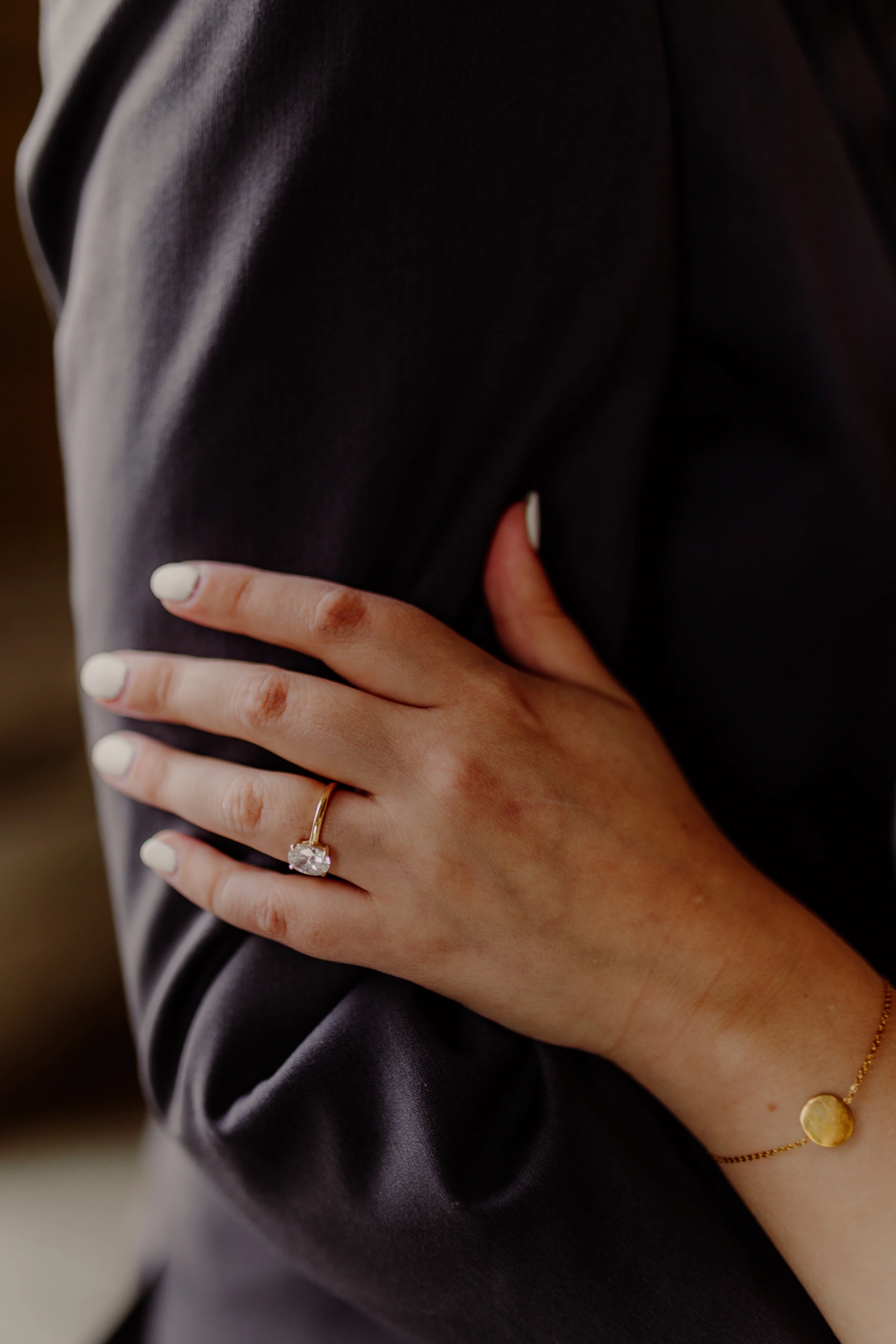 Close-up detail of hands on the groom suit jacket
