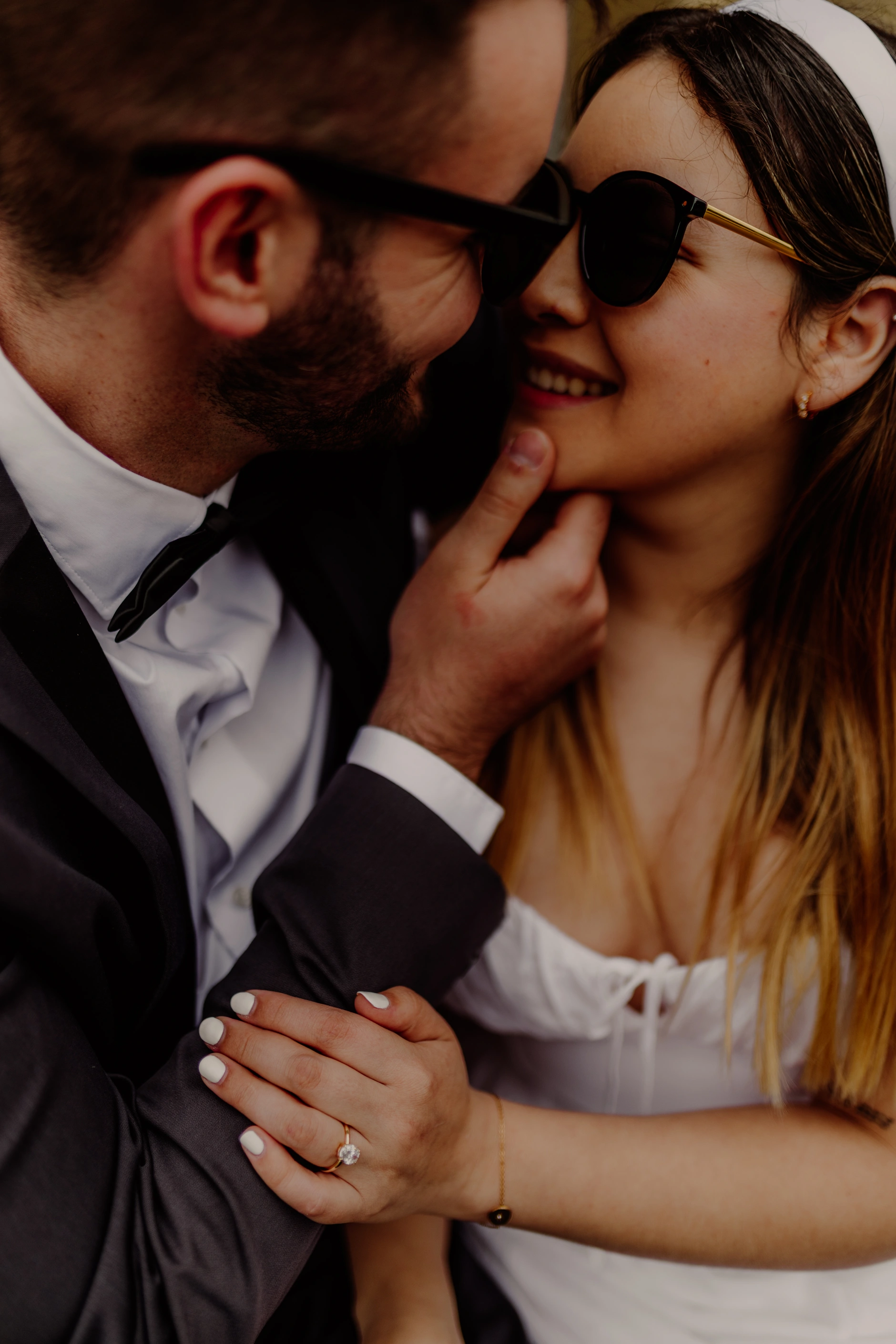 Intimate side profile of the couple with sunglasses