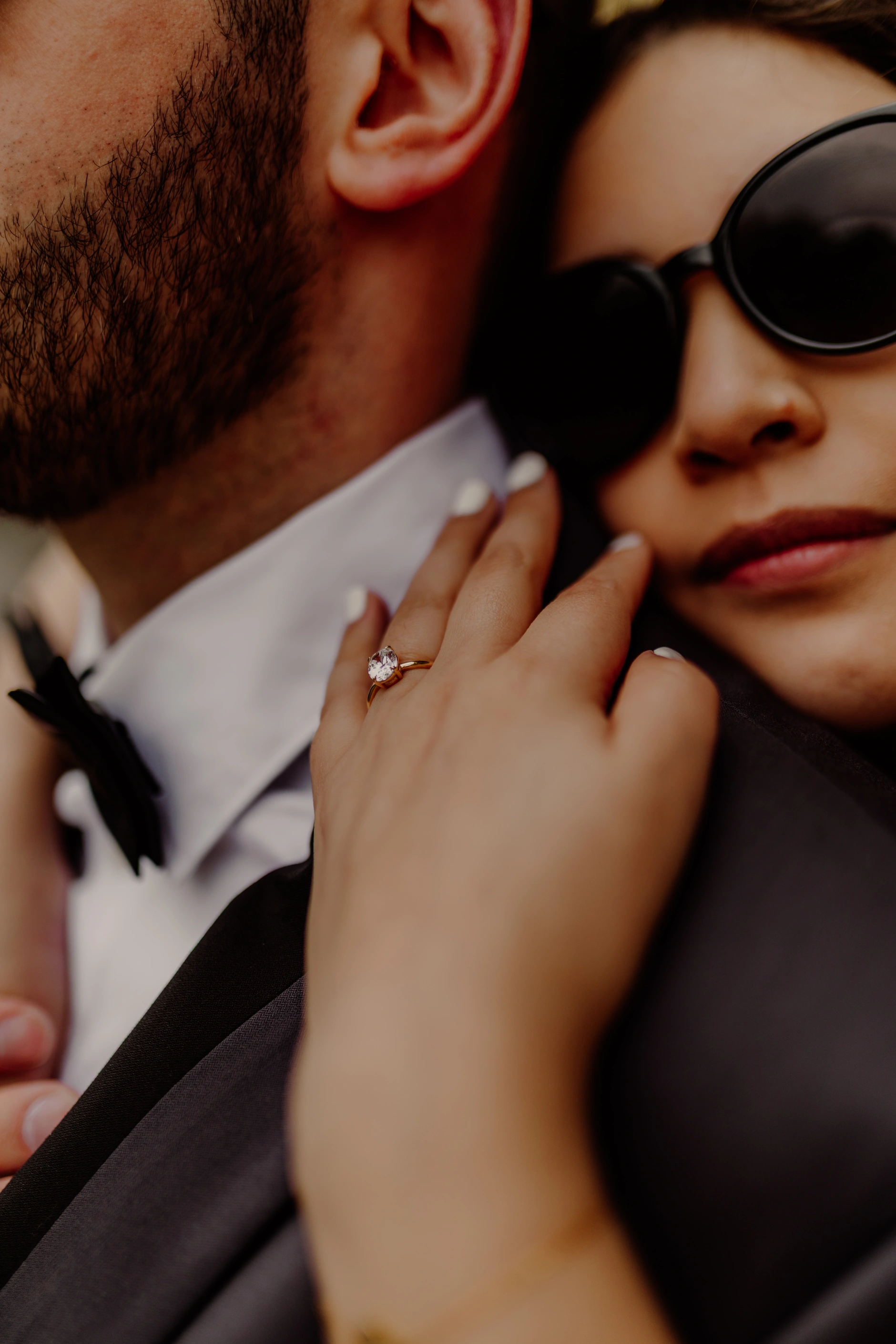 Close-up of jewelry and hand near the bride face