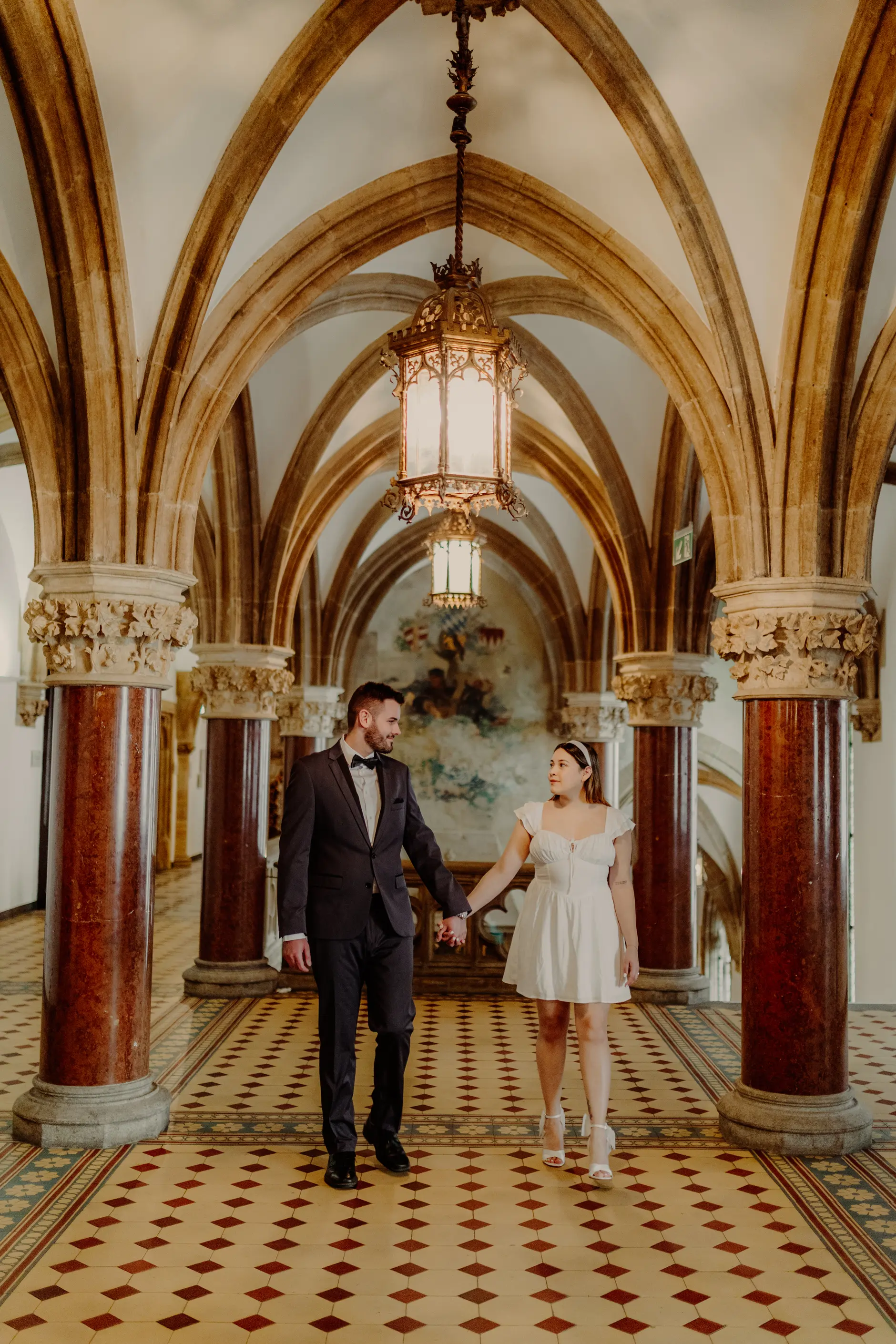 Groom standing in the vaulted Rathaus corridor
