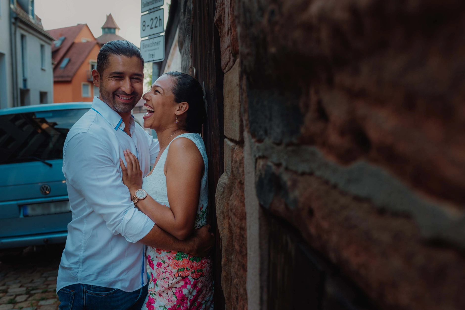 Couple embracing by a wooden wall in Old Town