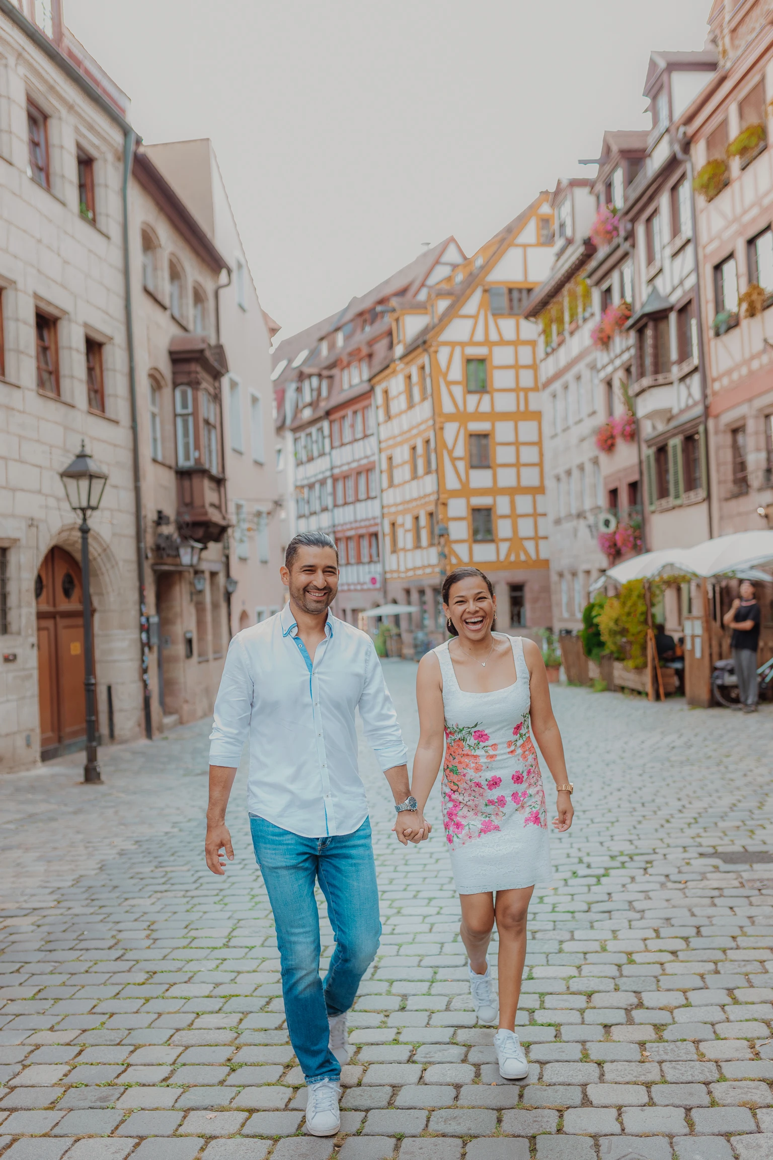 Woman walking through a cobblestone Old Town street