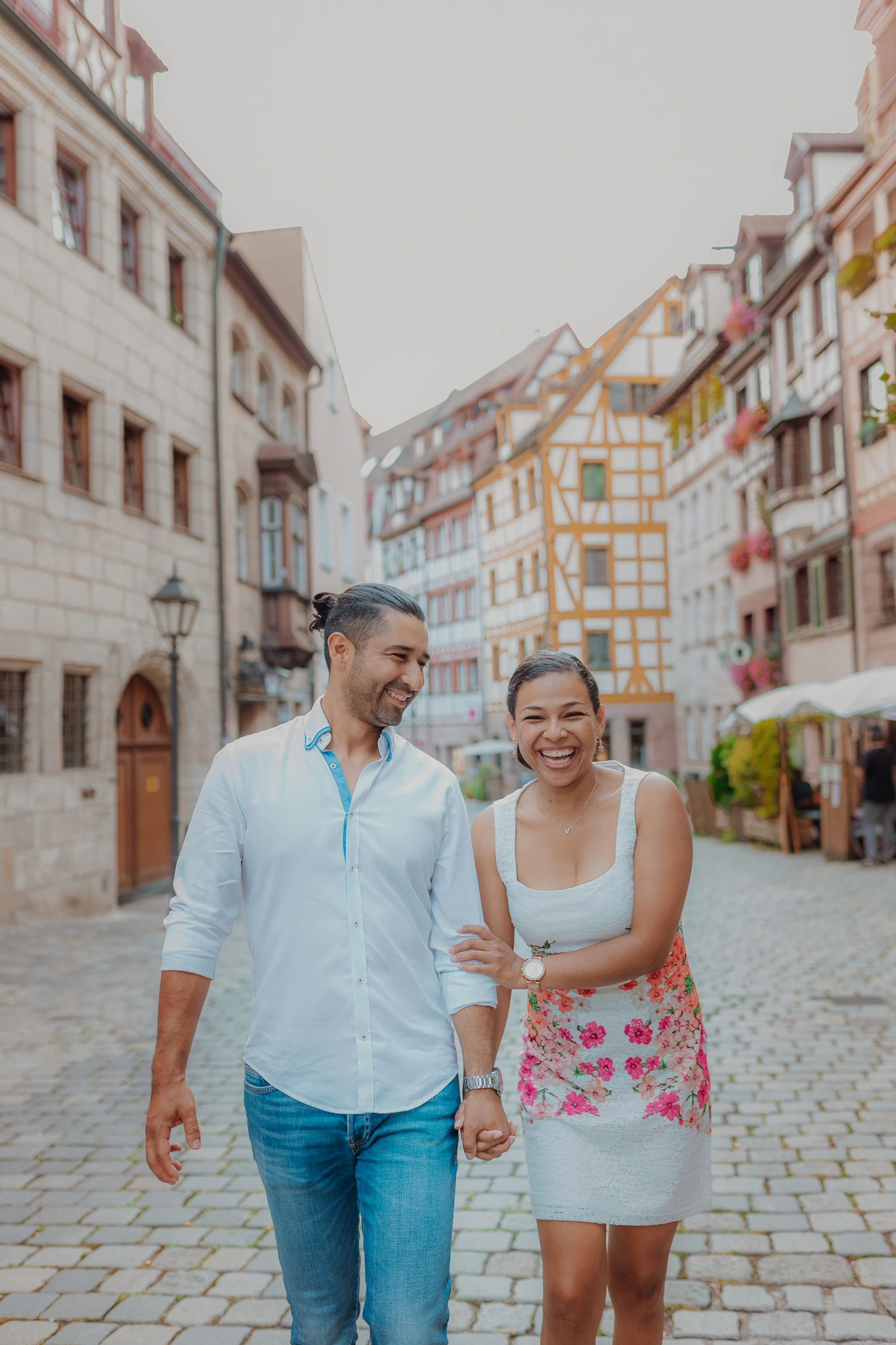 Couple walking hand in hand through Nuremberg Old Town