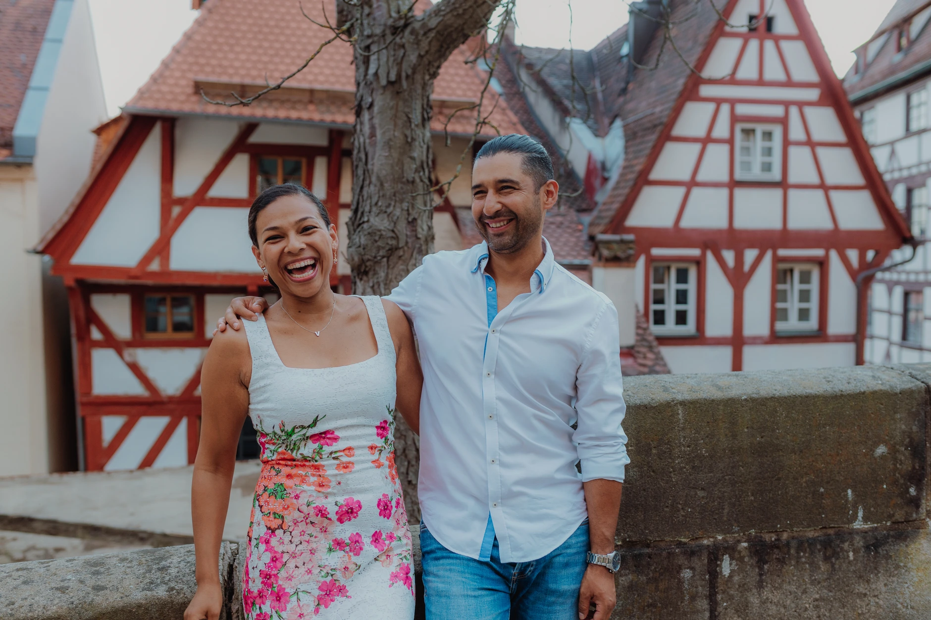 Final couple portrait in front of red and white half timbered houses