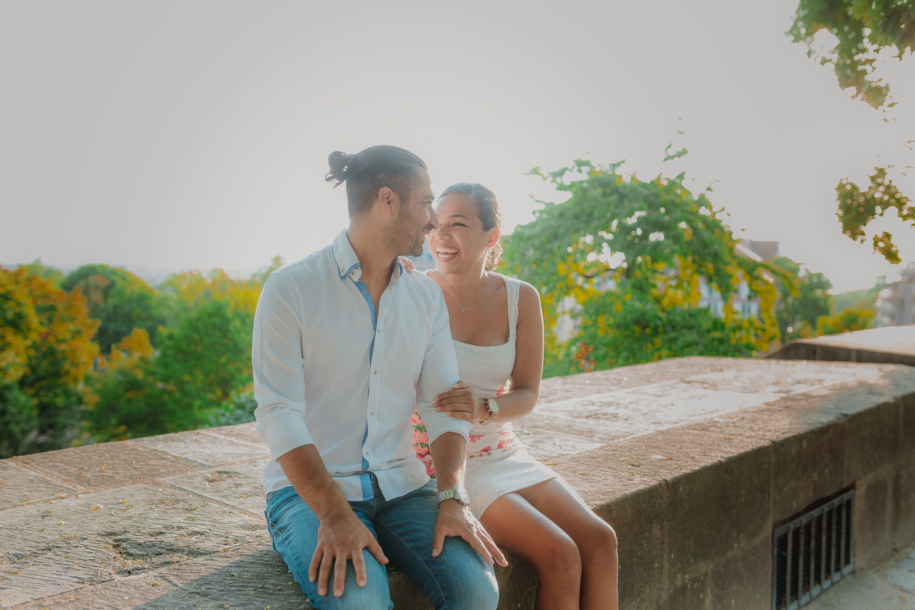 Couple seated on the wall with Nuremberg skyline behind
