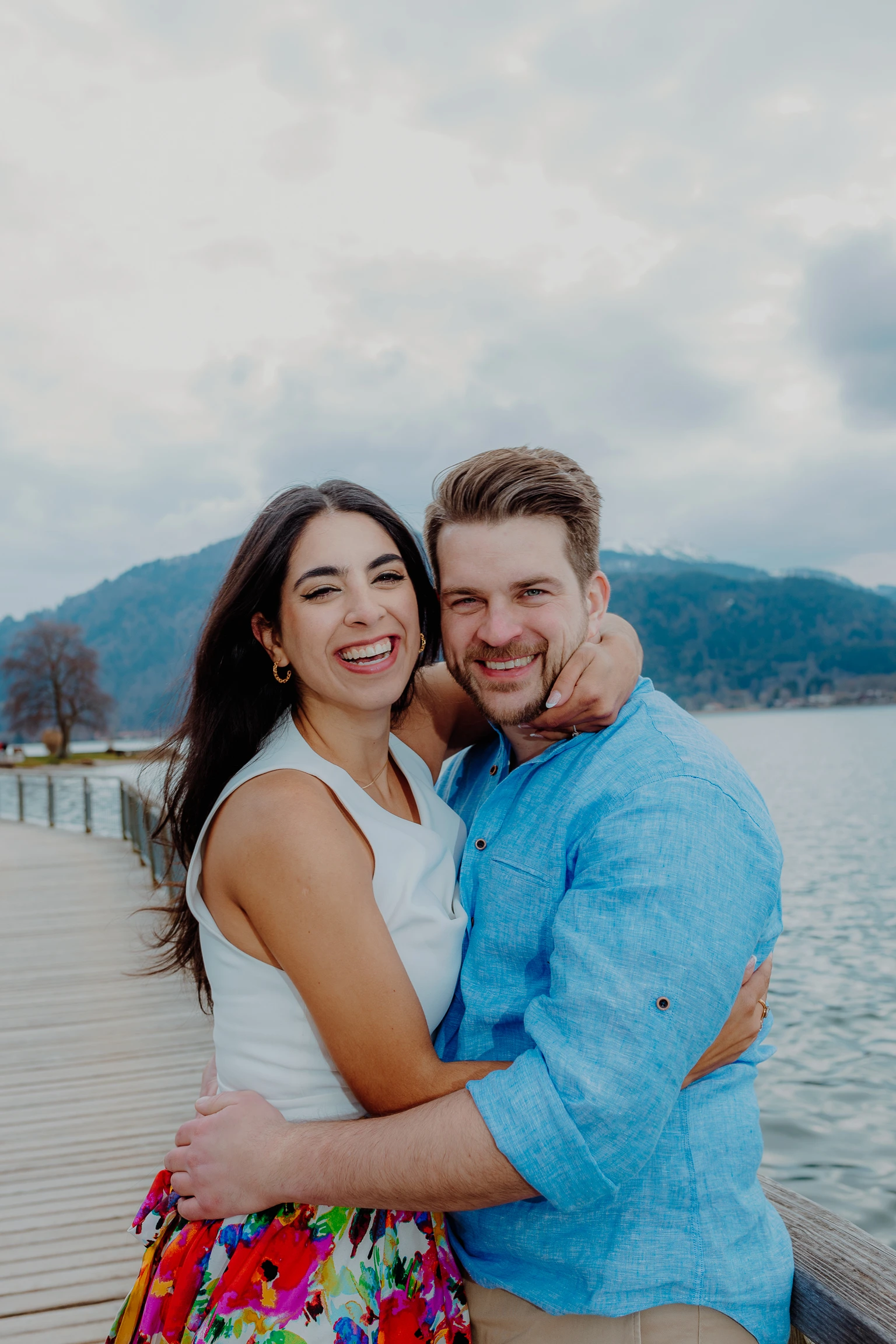 Couple portrait on the boardwalk railing at Tegernsee
