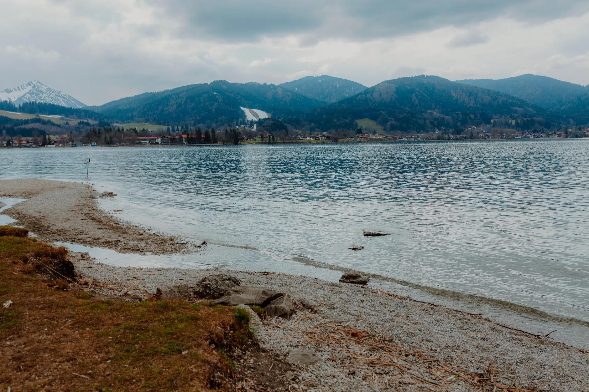 Tegernsee shoreline with waves and dramatic clouds