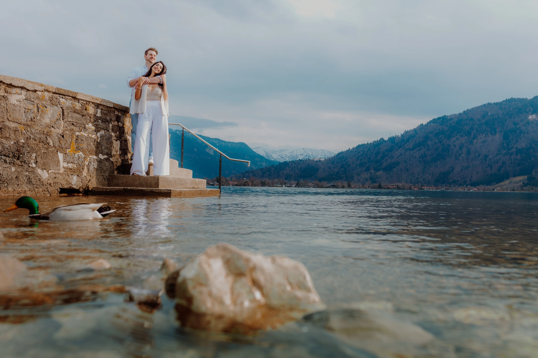 Wide lakeside portrait with the bride near the water