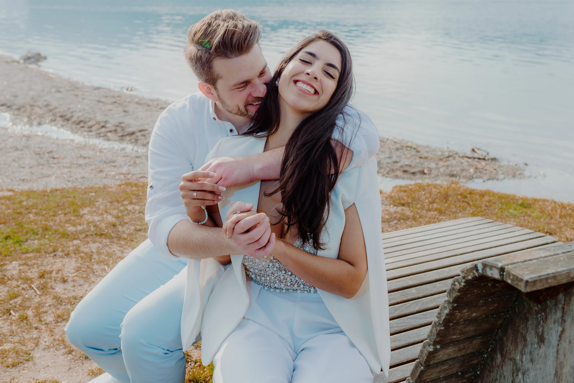Couple cuddling on a wicker beach chair