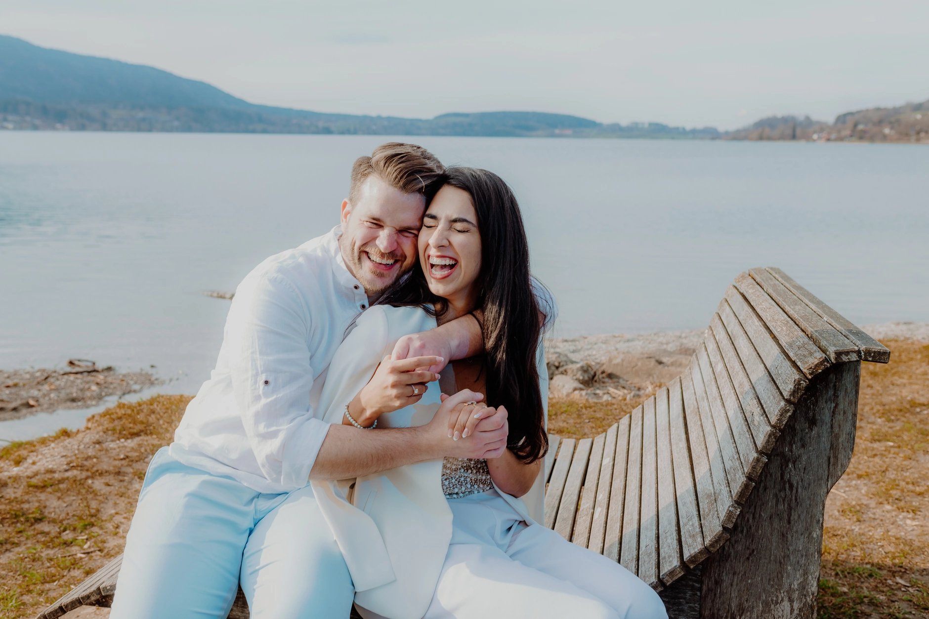 Second angle of the couple seated and smiling together