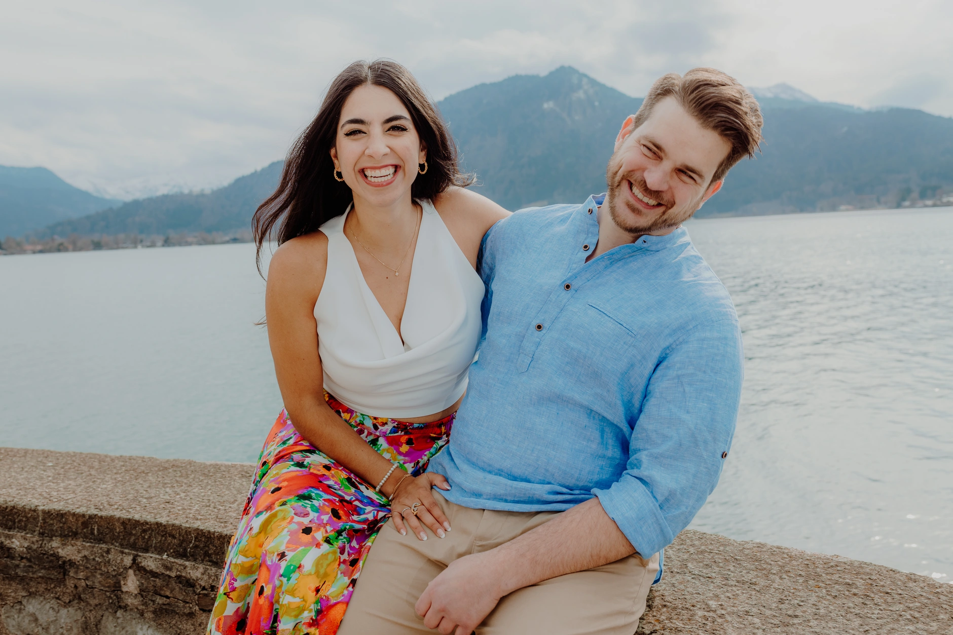 Couple portrait seated on the pier in Tegernsee
