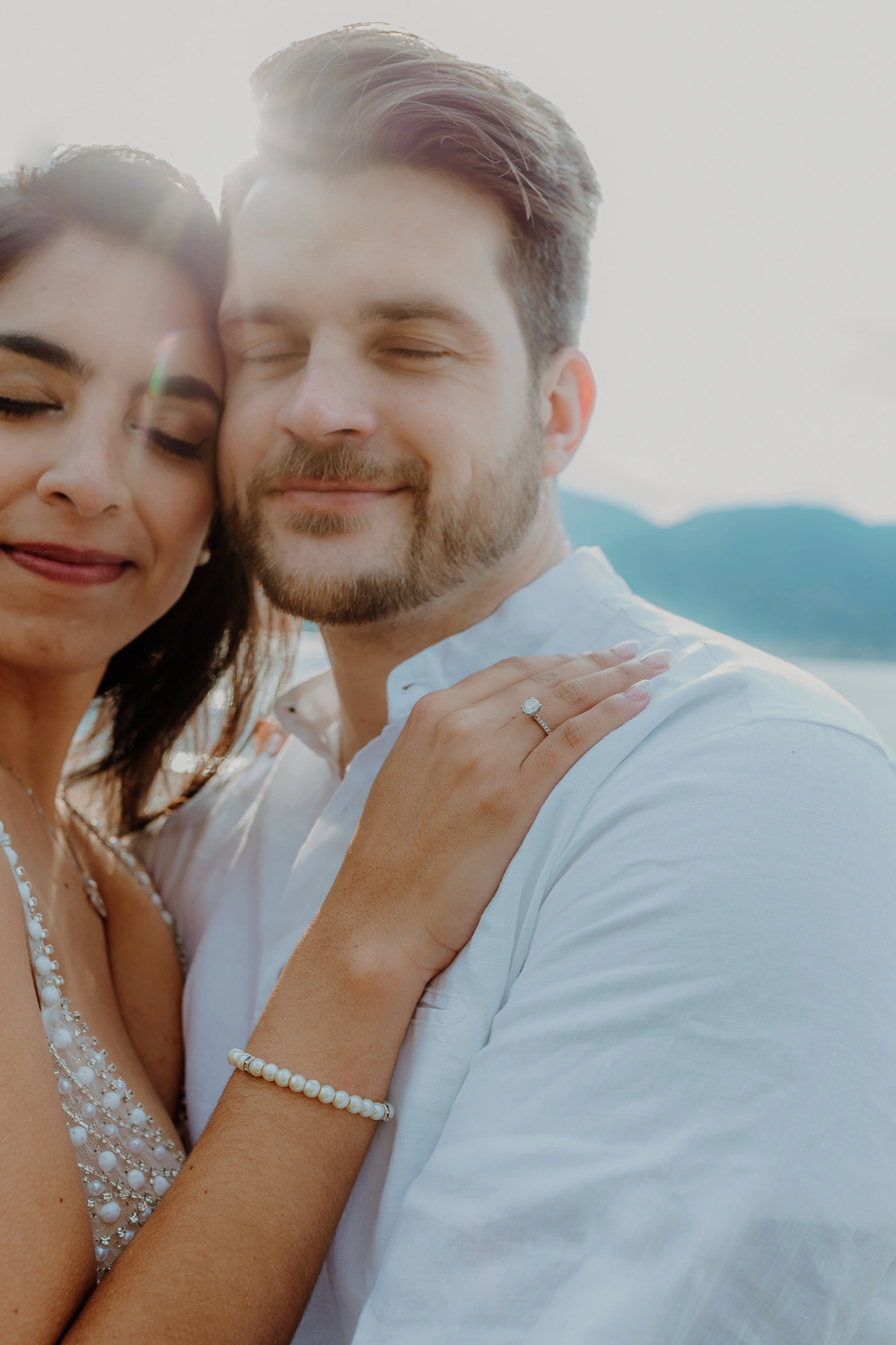 Selfie-style portrait with mountains behind the couple