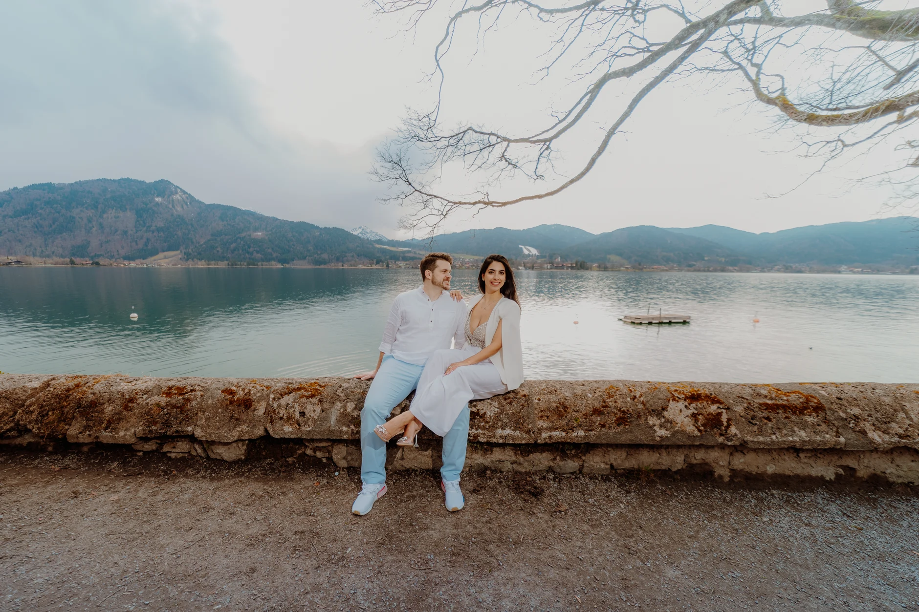 Couple walking hand in hand on the lakeside path