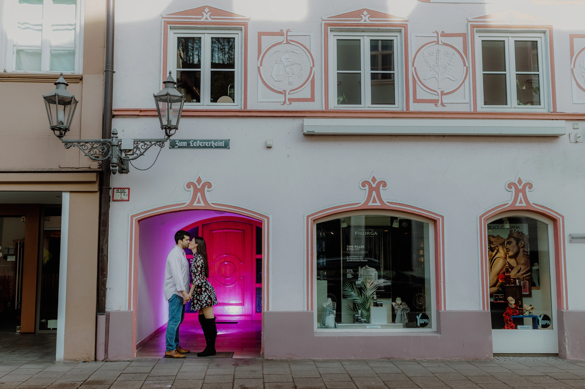 Man by a pink-lit doorway in Wolfratshausen