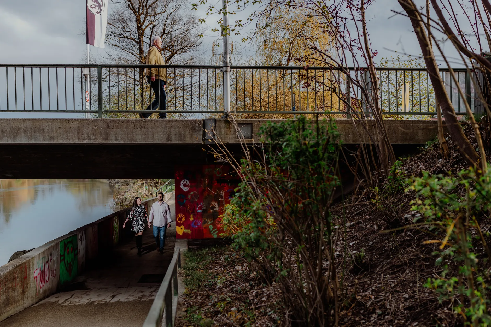 Graffiti underpass with a person walking in shadow