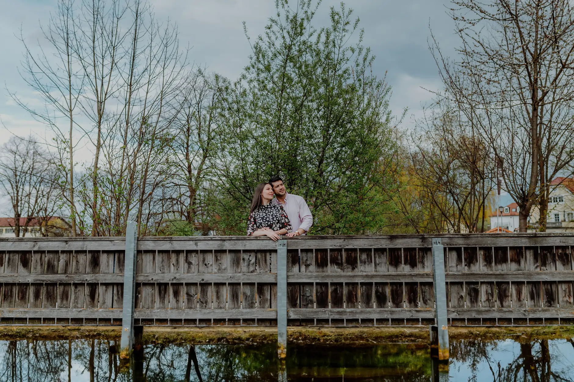 Bridge railing with spring trees by the Loisach river