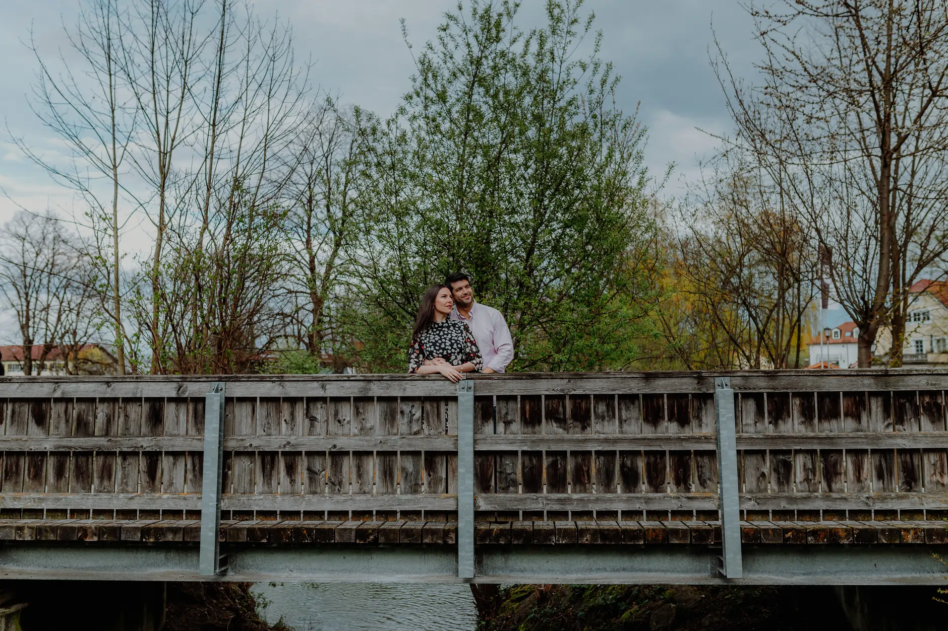 Couple portrait on the bridge with water in the background