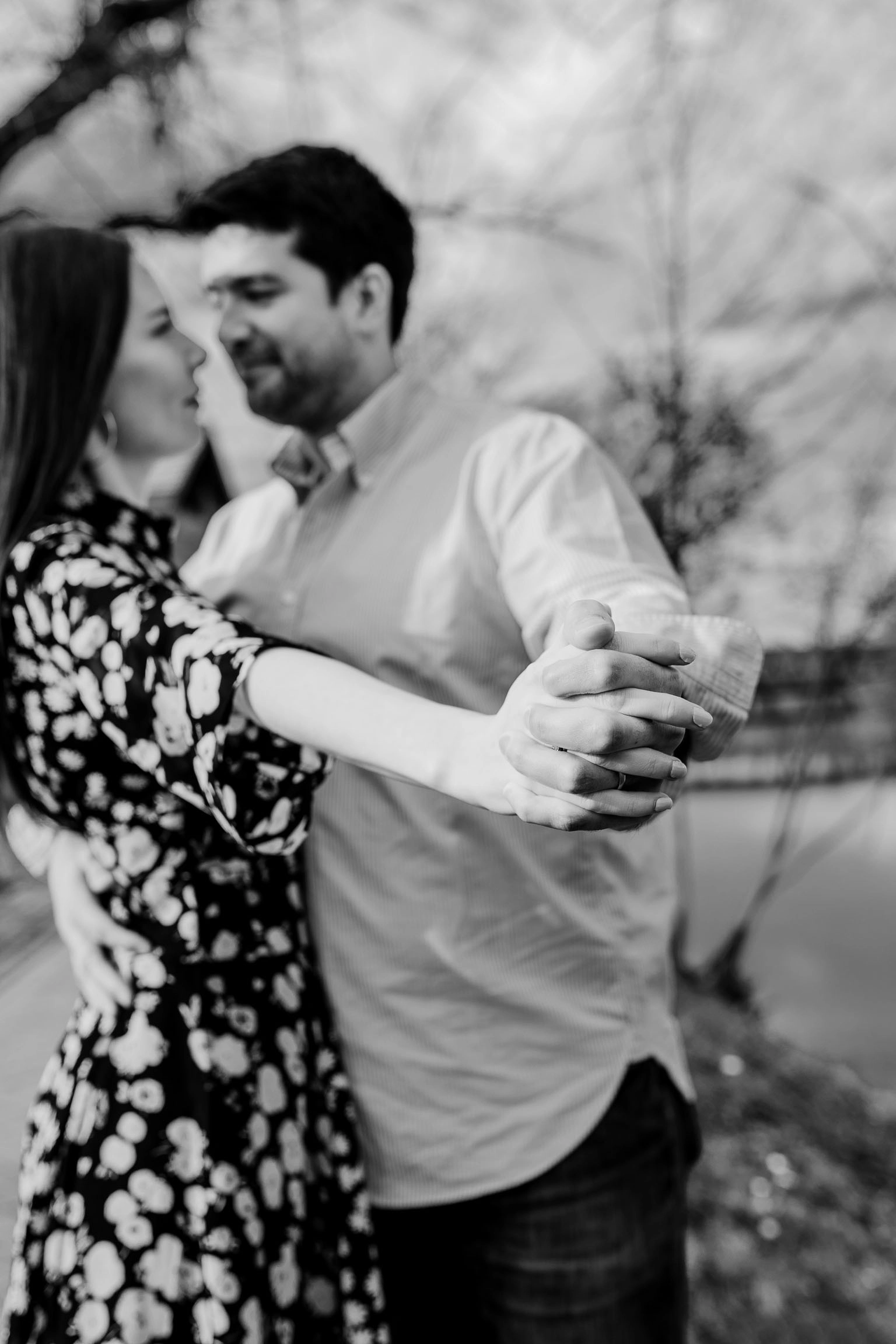 Black-and-white close-up portrait of the couple embracing