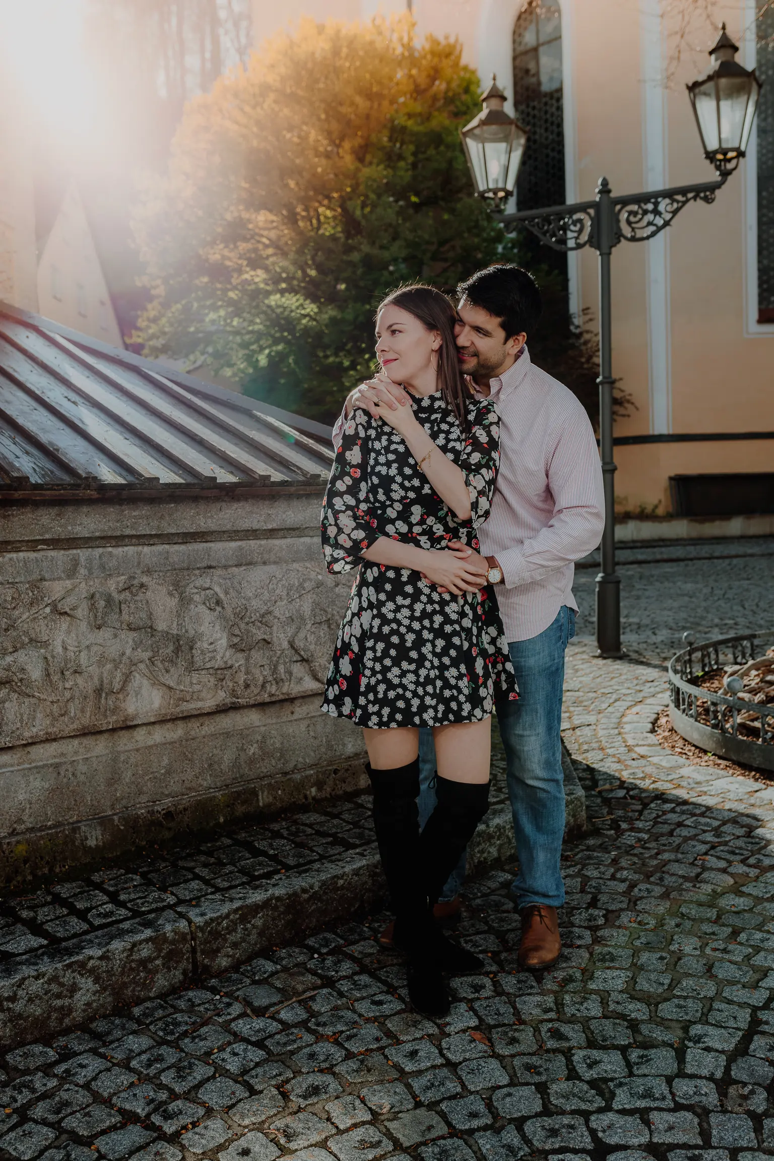 Woman in a floral dress by a turquoise facade